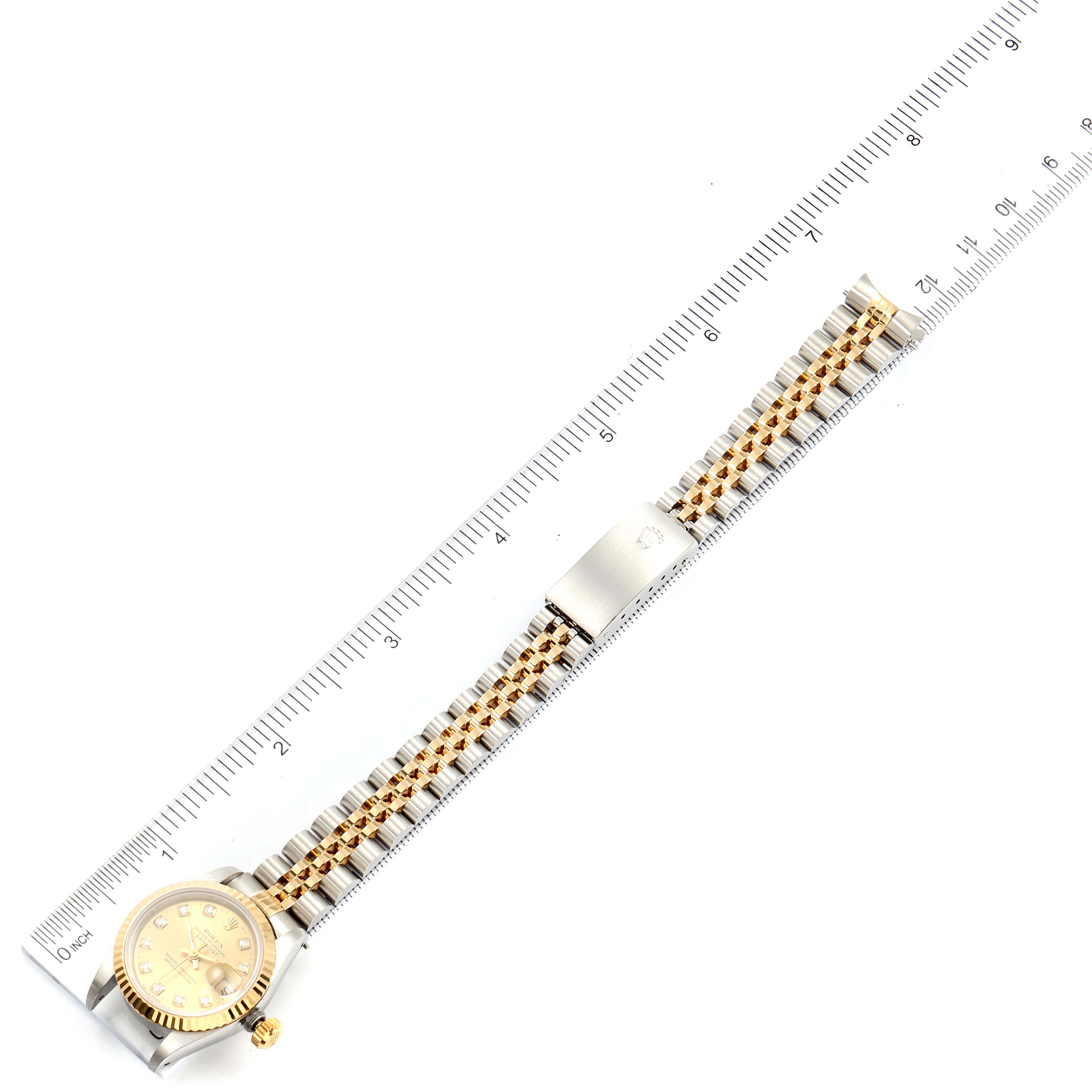 The Rolex Datejust 69173 Women's Steel and Gold (two tone) Champagne Dial 69173 Women's Steel and Gold (two tone) Champagne Dial watch is photographed from above, showing the entire bracelet and the 12-hour side of the face, with a ruler for scale.