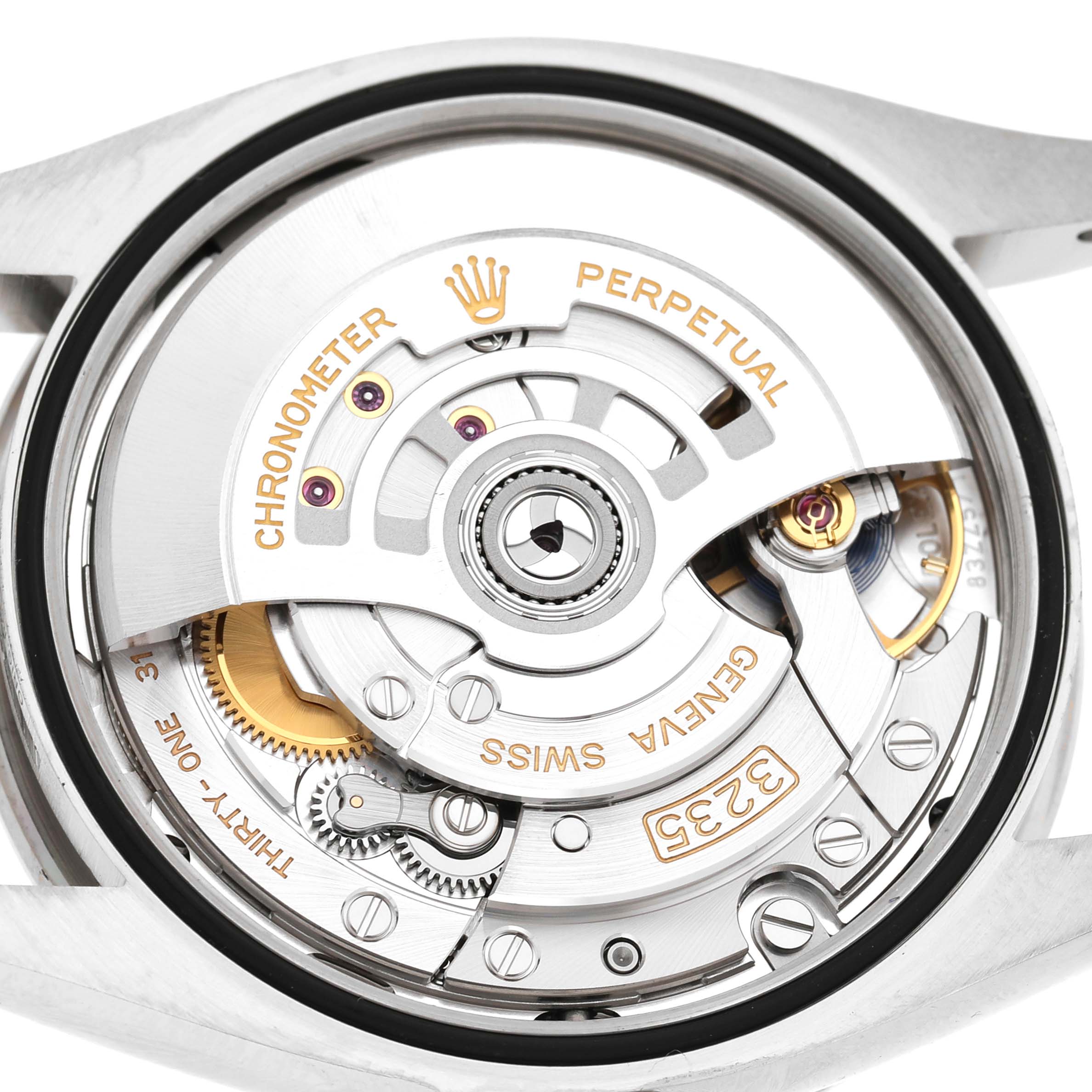 The image shows the movement mechanism of a Rolex Datejust 126284 Men's Stainless Steel Blue Dial watch from a rear angle, highlighting the rotor and gears.