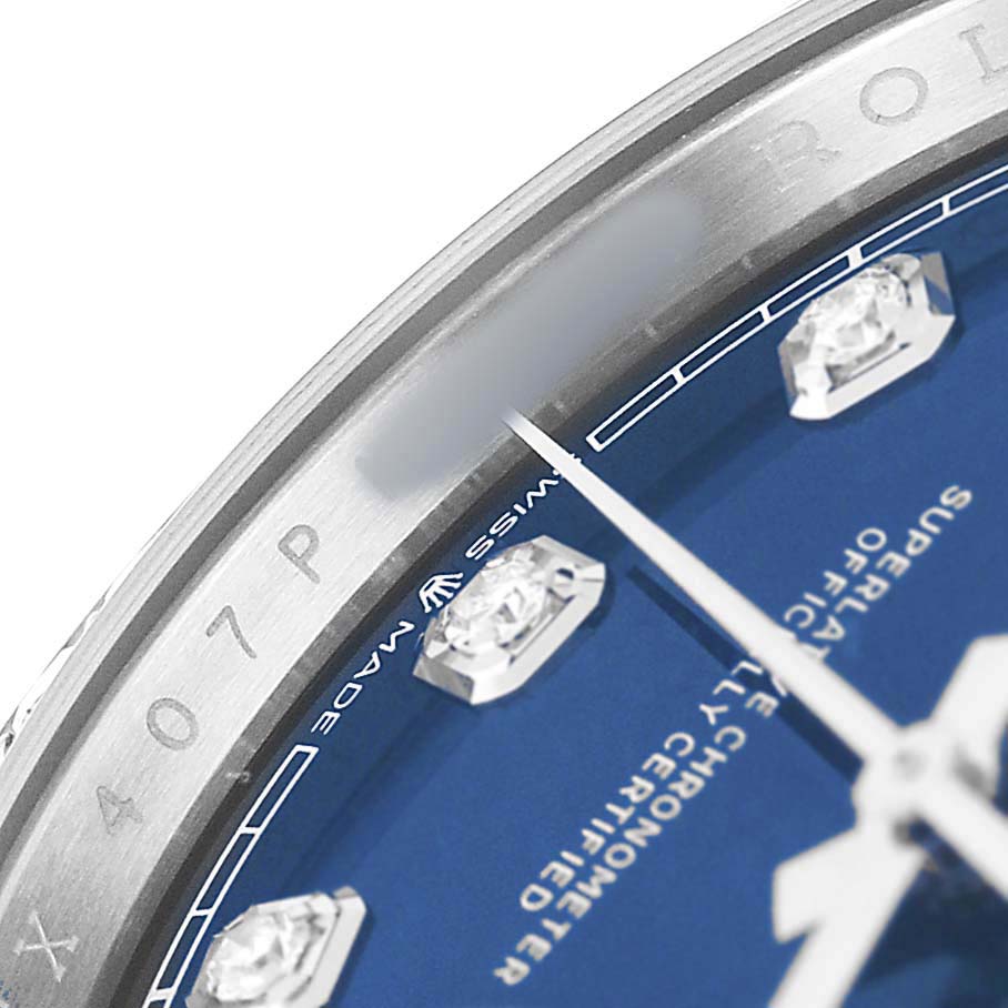 The close-up shows the bezel, dial, and part of the hands of a Rolex Datejust 126284 Men's Stainless Steel Blue Dial, highlighting the blue dial with diamond markers.