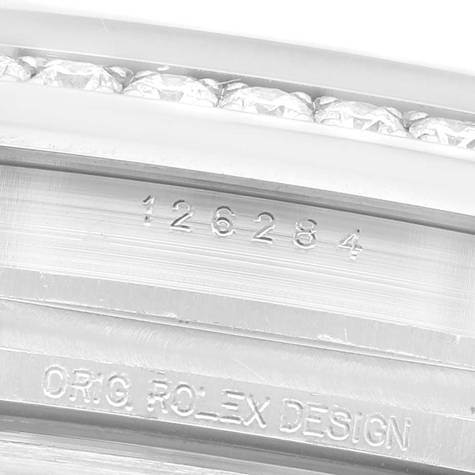 The image shows a close-up of the Rolex Datejust 126284 Men's Stainless Steel Purple Dial model’s bezel and engraving, highlighting the design details.