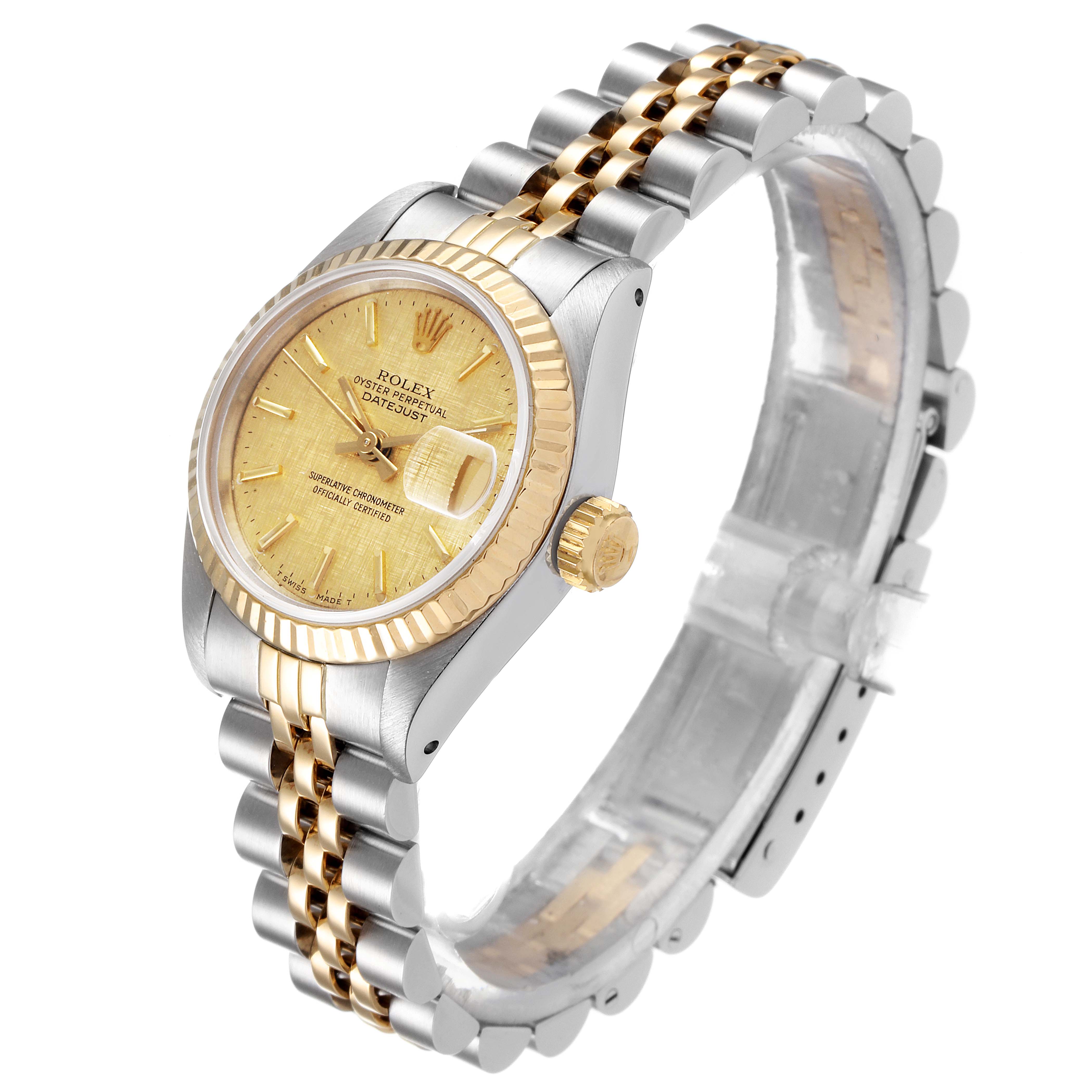 The image shows a Rolex Datejust 69173 Women's Steel and Gold (two tone) Champagne Dial 69173 Women's Steel and Gold (two tone) Champagne Dial watch from a three-quarter angle, highlighting its gold face, fluted bezel, and two-tone bracelet.