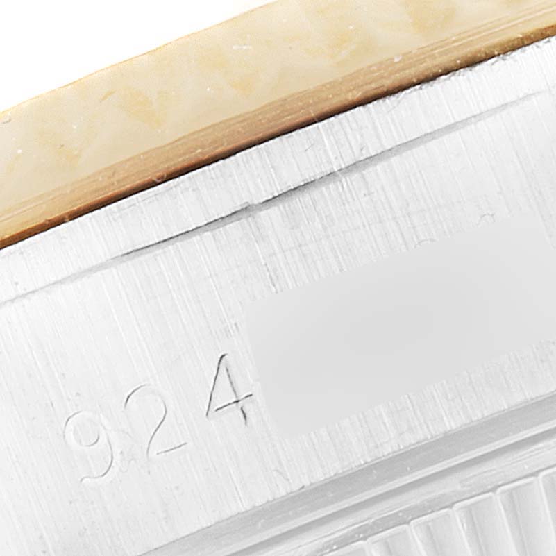 This close-up image shows the side view of the case with engraved serial numbers of a Rolex Datejust 69173 Women's Steel and Gold (two tone) Champagne Dial 69173 Women's Steel and Gold (two tone) Champagne Dial watch.