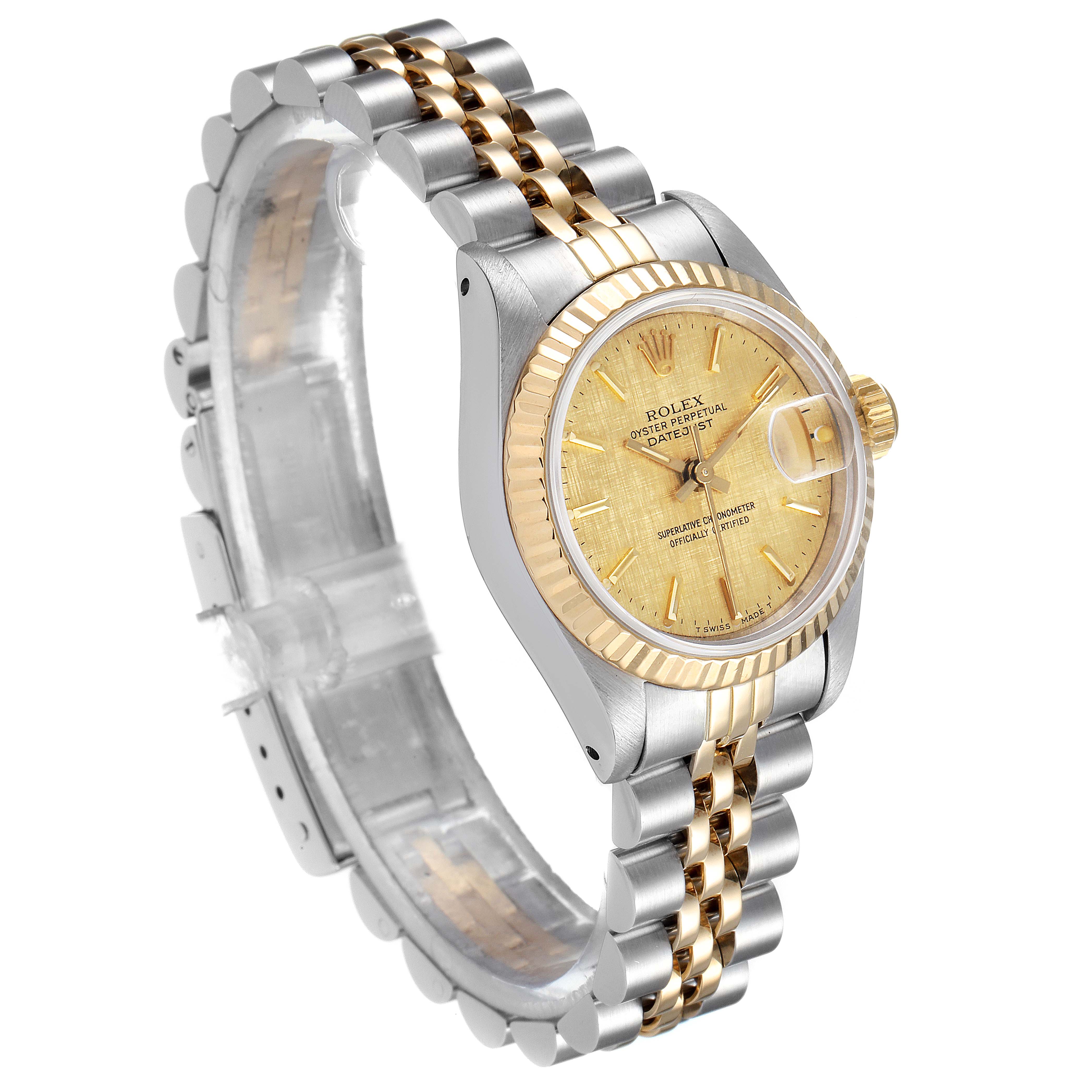 The image shows a side angle of a Rolex Datejust 69173 Women's Steel and Gold (two tone) Champagne Dial 69173 Women's Steel and Gold (two tone) Champagne Dial watch, featuring its gold dial, fluted bezel, and two-tone bracelet.