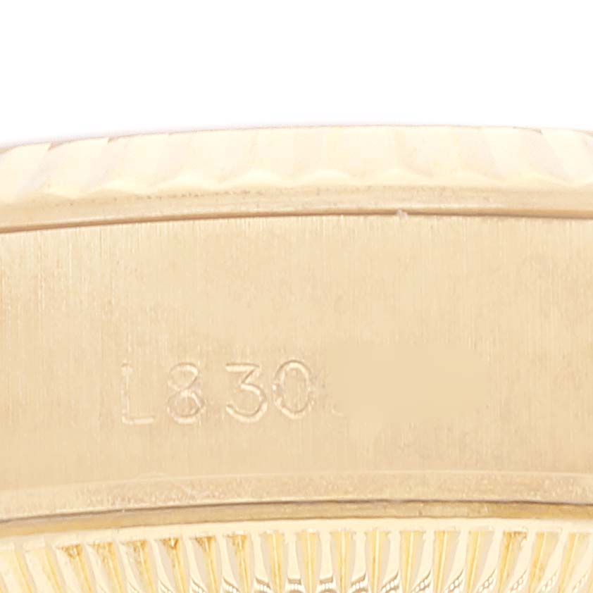 This image shows a close-up of the side of a Rolex President 69178 Women's Yellow Gold Champagne Dial 69178 Women's Yellow Gold Champagne Dial model watch, highlighting its serial number engraving.