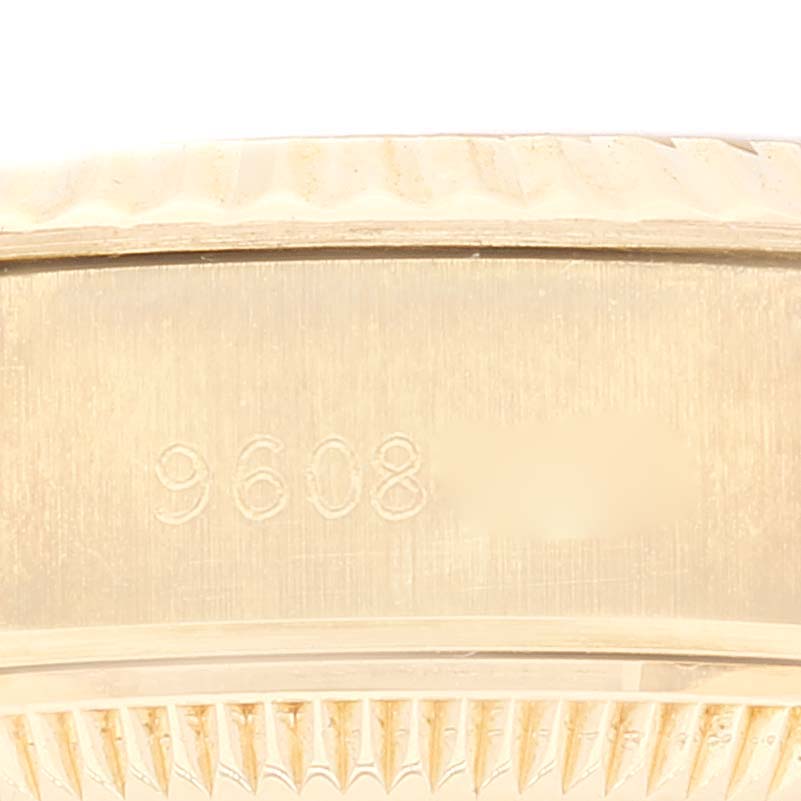 This image shows a close-up of the inner side of the bezel of a Rolex President 69178 Women's Yellow Gold Champagne Dial 69178 Women's Yellow Gold Champagne Dial model watch, displaying part of its serial number.