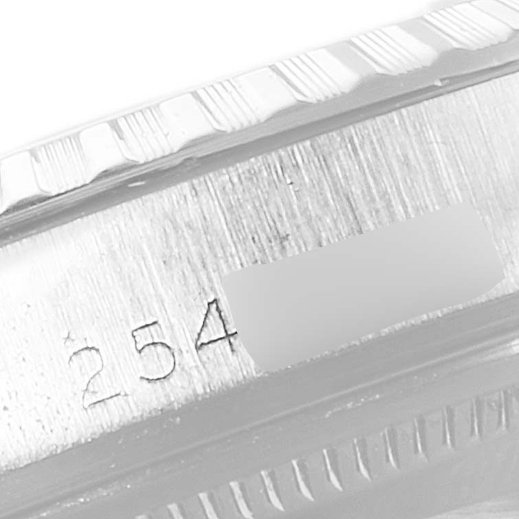 This close-up image shows the engraved serial number and part of the bezel of a Rolex Vintage Collection 1603 Men
s Stainless Steel Silver Dial 1603 Men
s Stainless Steel Silver Dial watch.