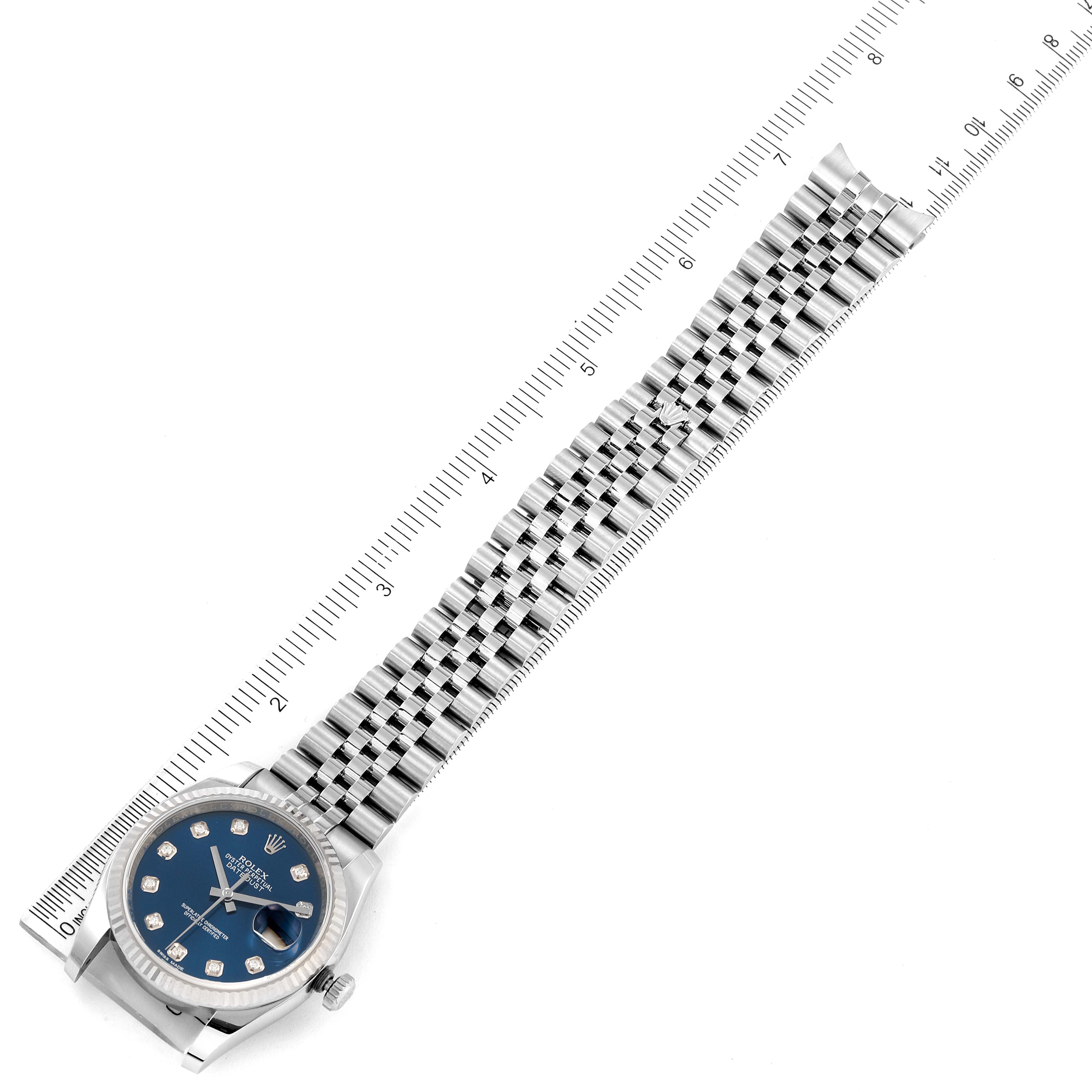 This image shows a Rolex Datejust 116234 Men's Stainless Steel Blue Dial 116234 Men's Stainless Steel Blue Dial watch from a slightly angled top view, including the face, dial, and metal bracelet measured against a ruler.