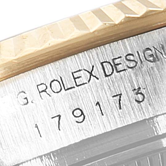 The image shows a close-up of the serial number engraving on the side of a Rolex Datejust 179173 Women's Steel and Gold (two tone) Black Dial 179173 Women's Steel and Gold (two tone) Black Dial watch bezel and case.