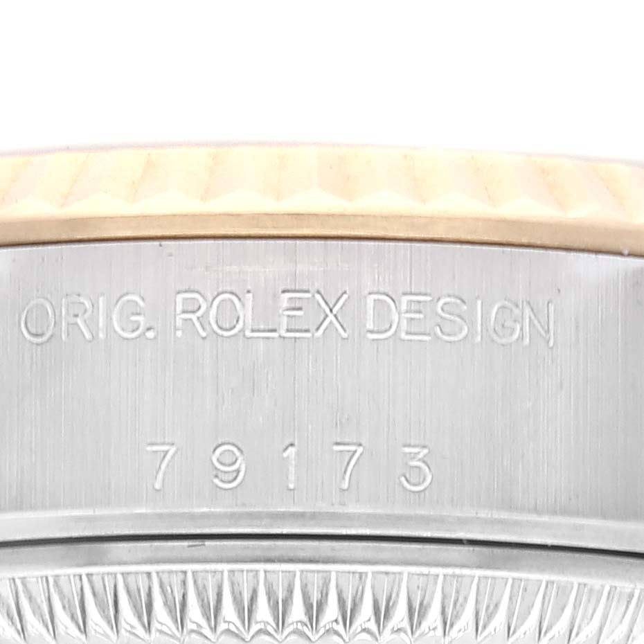 This close-up image shows the words "ORIG. ROLEX DESIGN" and the model number "79173" of the Rolex Datejust 79173 Women's Steel and Gold (two tone) Champagne Dial 79173 Women's Steel and Gold (two tone) Champagne Dial watch case.