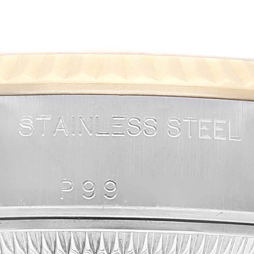 The image shows a close-up of the Rolex Datejust 79173 Women's Steel and Gold (two tone) Champagne Dial 79173 Women's Steel and Gold (two tone) Champagne Dial model's stainless steel case with engraved text and part of the bezel.