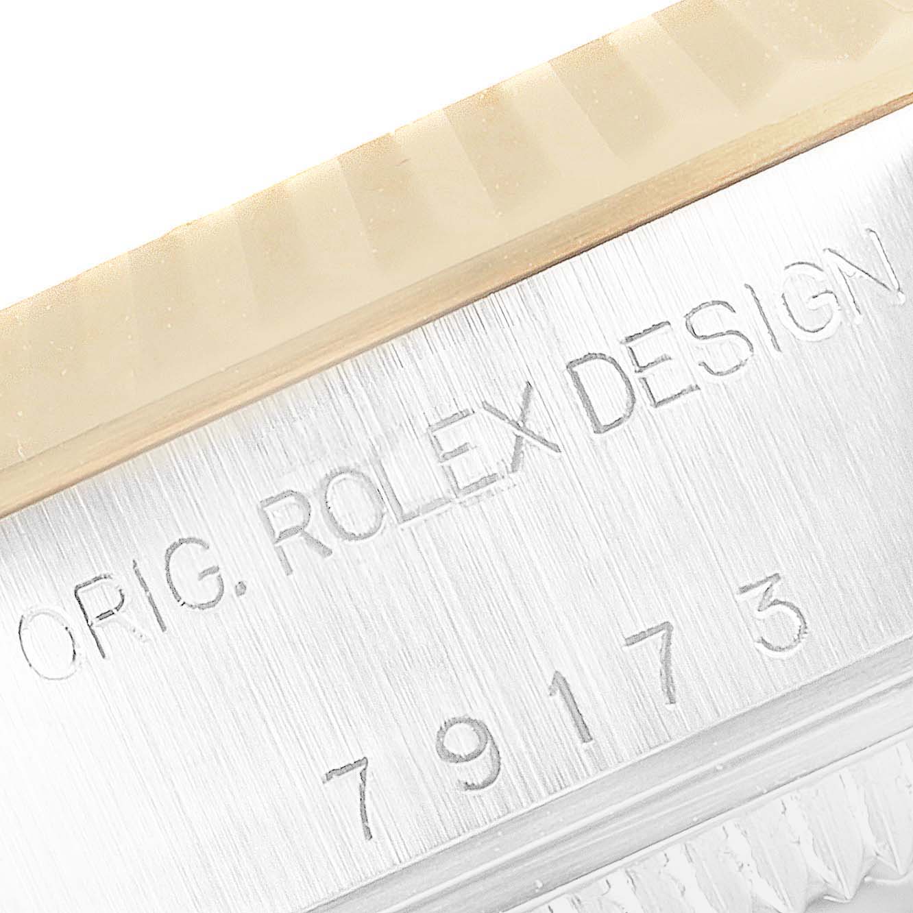 The image shows a close-up of the serial number and branding engraved on the side of a Rolex Datejust 79173 Women's Steel and Gold (two tone) Champagne Dial 79173 Women's Steel and Gold (two tone) Champagne Dial watch case.