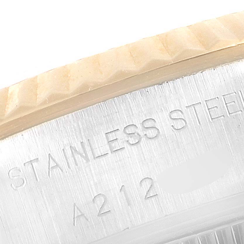 Close-up of the stainless steel case with engraving and part of the bezel of a Rolex Datejust 79173 Women's Steel and Gold (two tone) Champagne Dial 79173 Women's Steel and Gold (two tone) Champagne Dial watch.