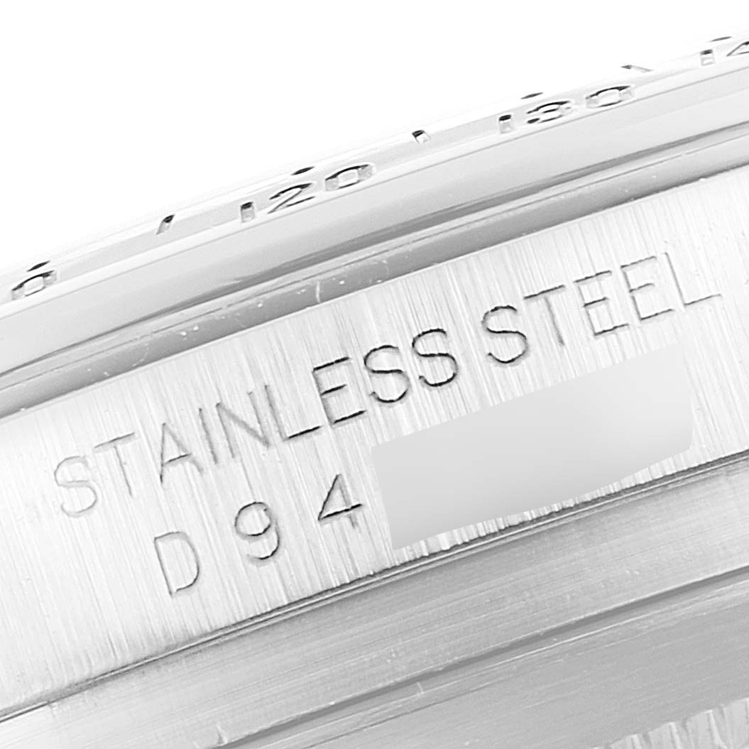 This image shows a close-up of the side of the stainless steel casing of a Rolex Daytona 116520 Men's Stainless Steel Black Dial 116520 Men's Stainless Steel Black Dial watch, displaying its engraved details.