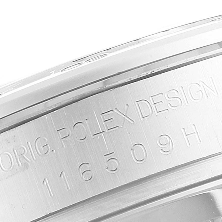 The image shows a close-up of the engraved case side and bezel of a Rolex Daytona 116509 Men's White Gold Blue Dial 116509 Men's White Gold Blue Dial watch.