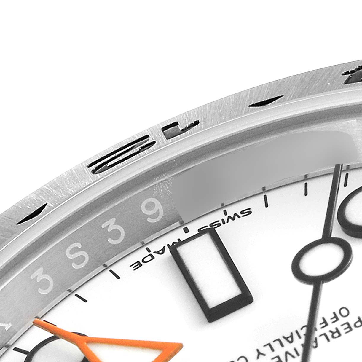 This image shows a close-up of the bezel and part of the dial of a Rolex Explorer 216570 Men
s Stainless Steel White Dial 216570 Men
s Stainless Steel White Dial watch.