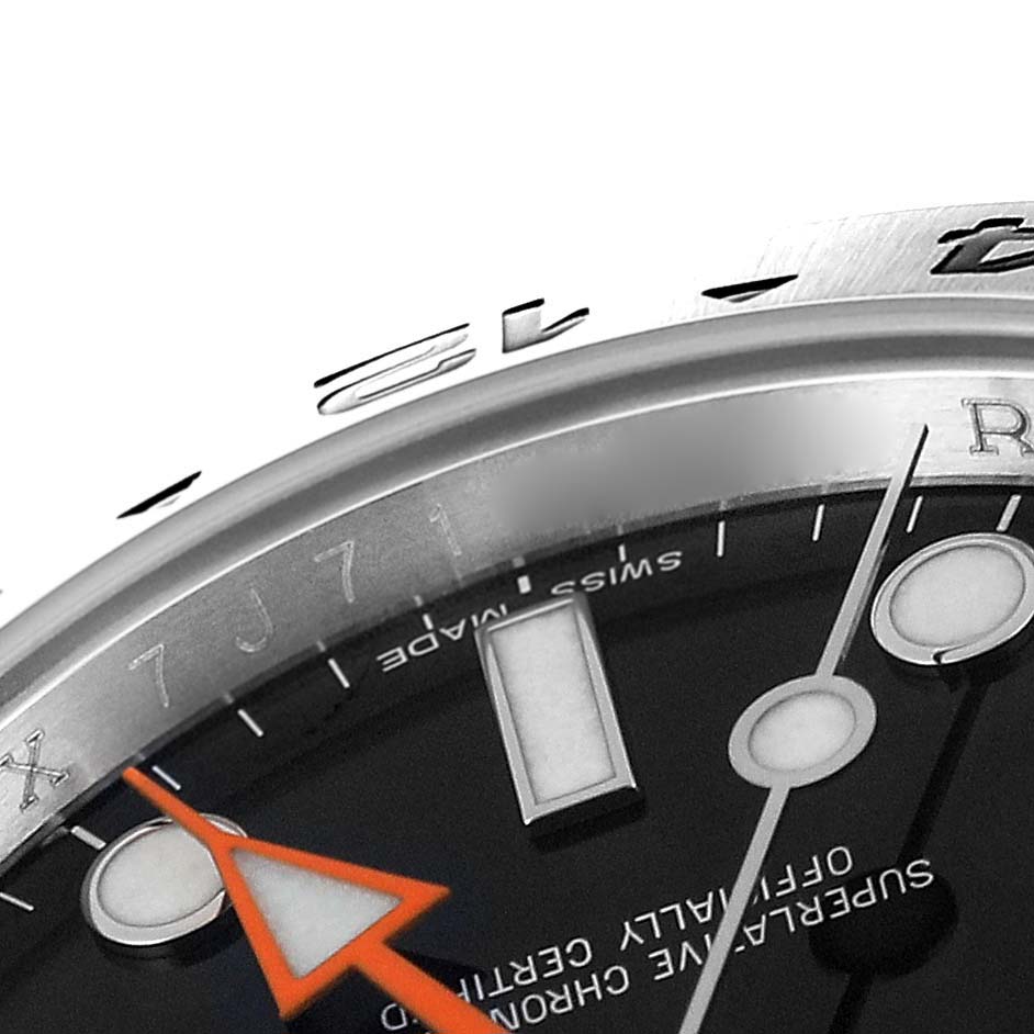 This close-up shows the bezel, part of the dial, and hands of a Rolex Explorer 216570 Men's Stainless Steel Black Dial 216570 Men's Stainless Steel Black Dial watch.