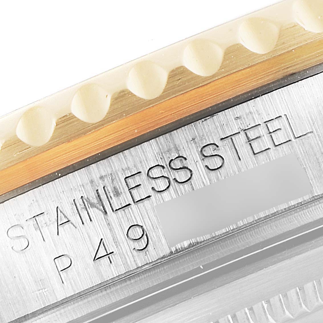 The image shows a close-up of the side of the stainless steel case and bezel of a Rolex GMT-Master 16713 Men's Steel and Gold (two tone) Champagne Dial 16713 Men's Steel and Gold (two tone) Champagne Dial watch.