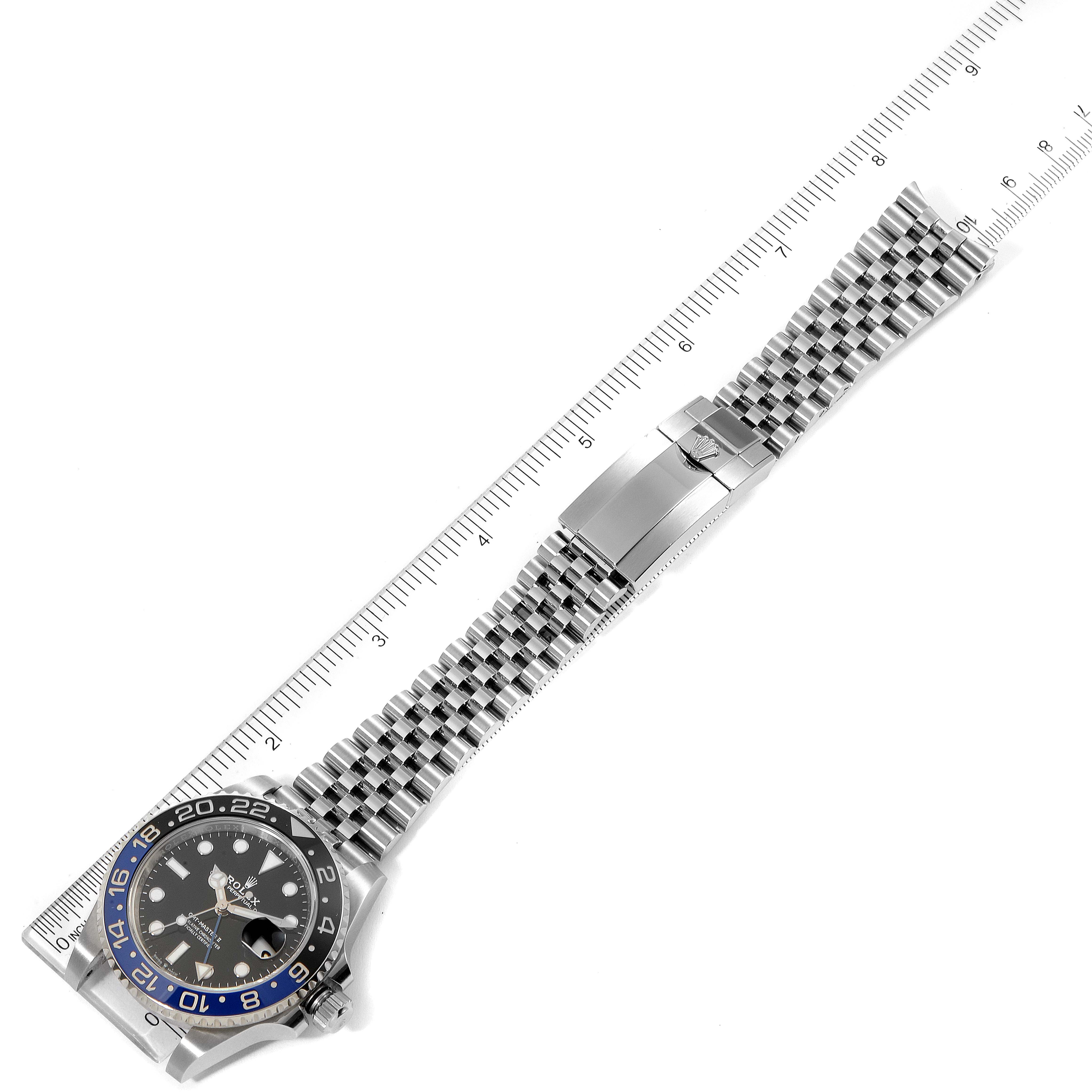 This image shows a top view of a Rolex GMT-Master 126710 Men
s Stainless Steel Black Dial 126710 Men
s Stainless Steel Black Dial watch with a ruler measuring its length.