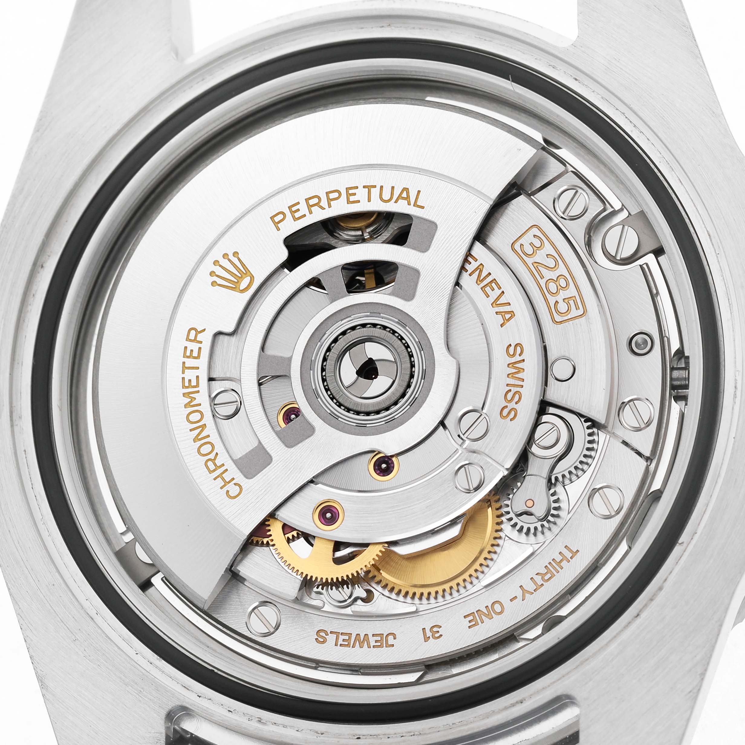 The image shows a close-up view of the movement inside the Rolex GMT-Master 126710 Men's Stainless Steel Black Dial, revealing the intricate gears and rotor mechanism.