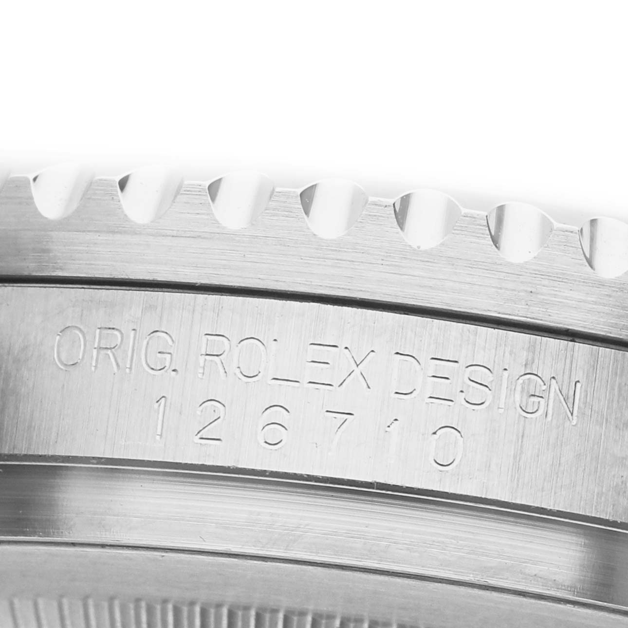 The image shows a close-up of the engraved side of a Rolex GMT-Master 126710 Men's Stainless Steel Black Dial watch case with its model number.