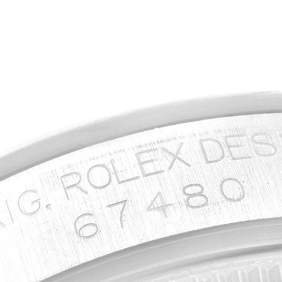 The image shows a close-up angle of the engraved bezel or case of a Mid-Size Rolex watch, featuring the model number 67480.