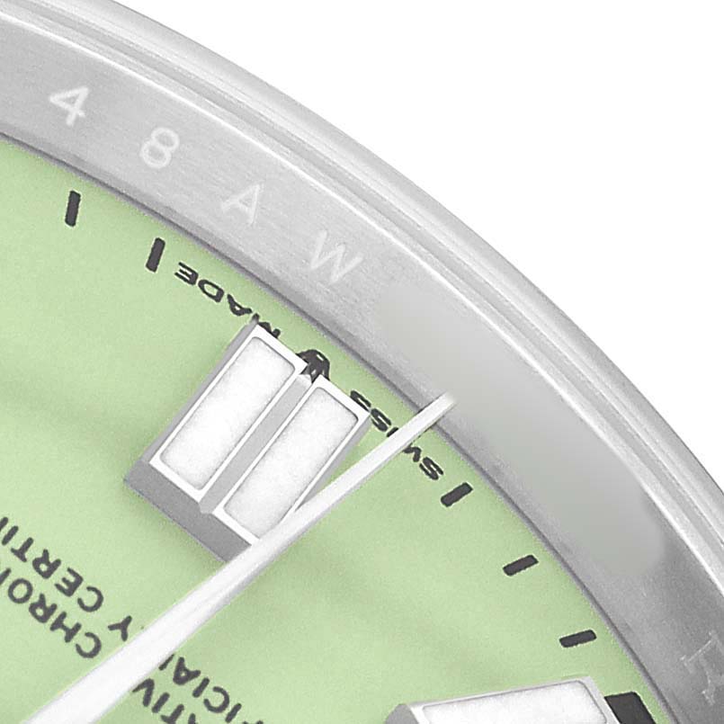 This image of the Rolex Oyster Perpetual 134300 Men's Stainless Steel Green Dial watch shows a close-up of the dial, hands, and part of the bezel.