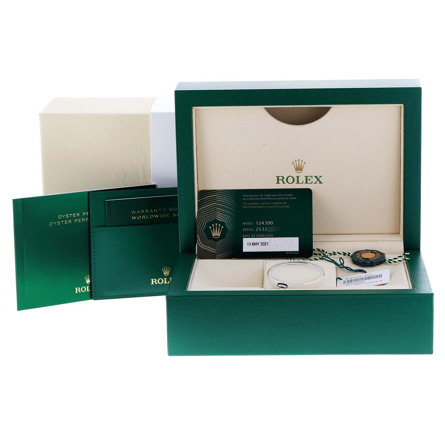The image shows the packaging and accessories of a Rolex Oyster Perpetual 124300 Men
s Stainless Steel Green Dial 124300 Men
s Stainless Steel Green Dial watch, including the box, warranty card, booklet, and tag.
