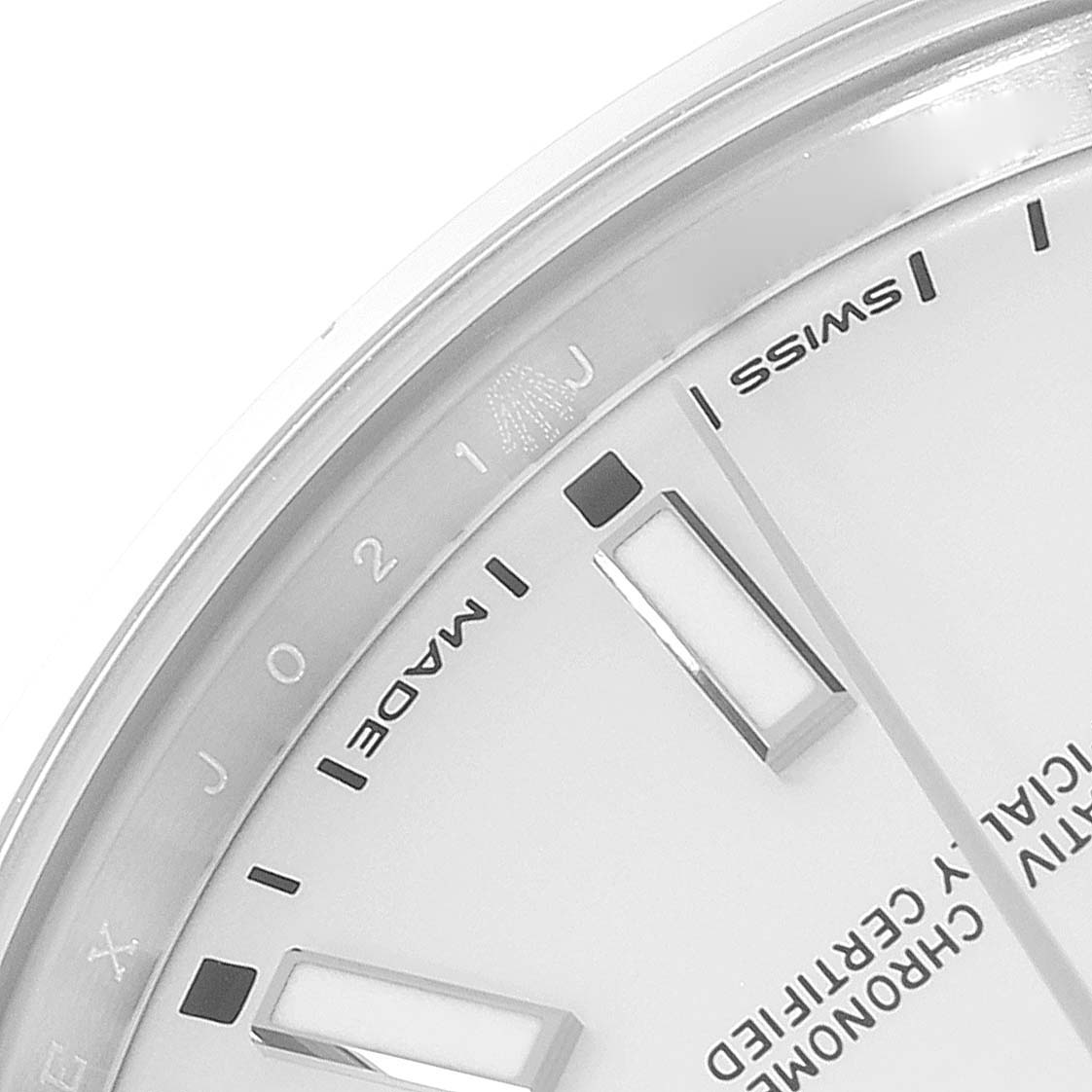 This image shows a close-up of the dial of a Rolex Oyster Perpetual 114300 Men's Stainless Steel Silver Dial 114300 Men's Stainless Steel Silver Dial watch, focusing on the text "SWISS MADE" and surrounding markers.