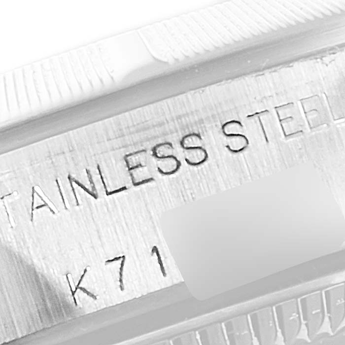 This is a close-up angle showing the stainless steel engraving on the bezel or case of the Rolex Oyster Perpetual 76030 Women
s Stainless Steel White Dial 76030 Women
s Stainless Steel White Dial watch.