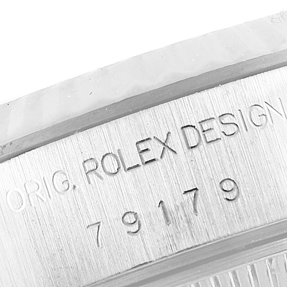 The image shows a close-up of the serial number and "ROLEX DESIGN" engraving on the side of a Rolex President 79179 Women's White Gold Silver Dial 79179 Women's White Gold Silver Dial model watch.
