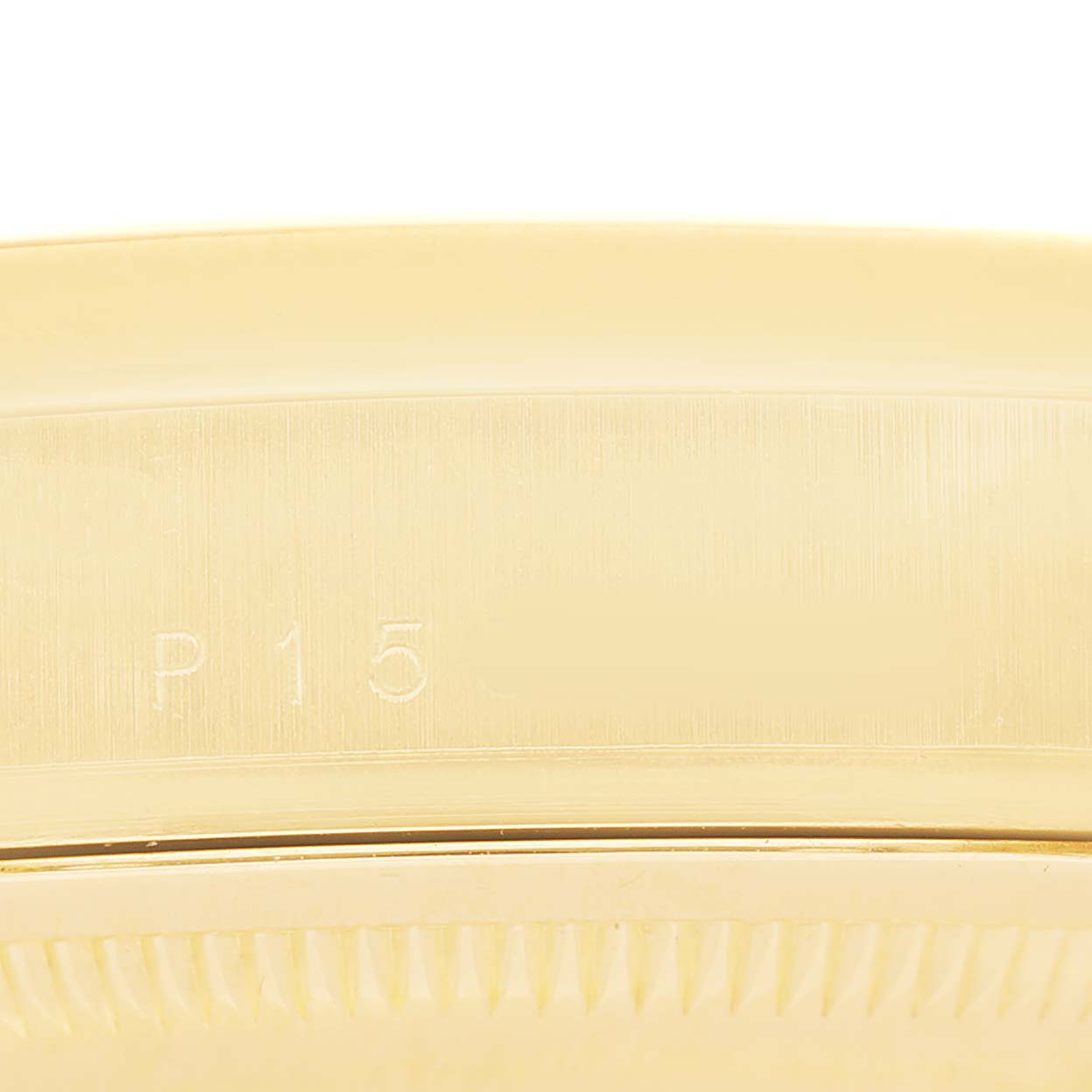 The image shows a close-up of the side and edge of a Rolex President 118208 Men's Yellow Gold Black Dial watch, highlighting its gold-toned bezel.