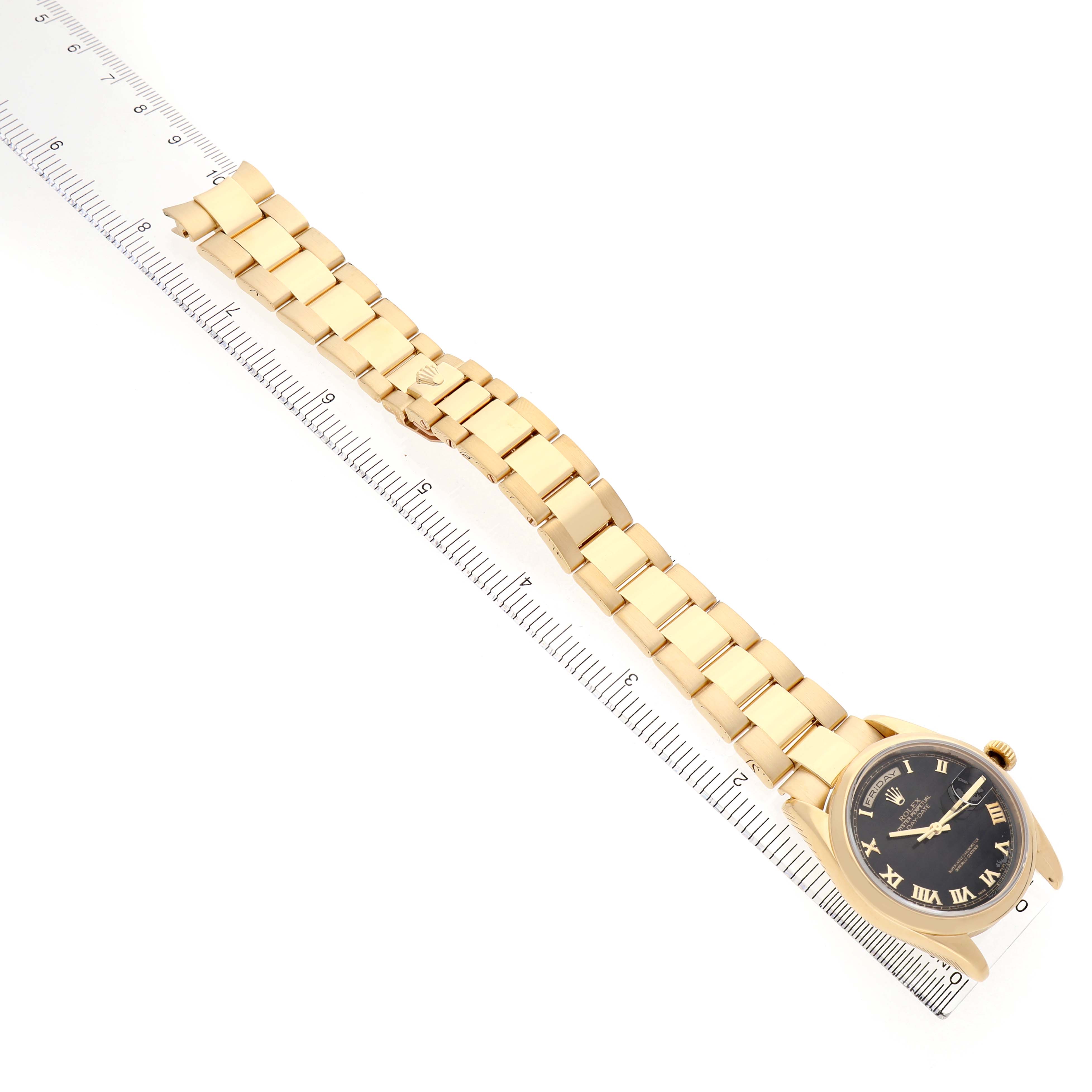 The Rolex President 118208 Men's Yellow Gold Black Dial watch is displayed at an angled view, showing the bracelet, dial with Roman numerals, and crown.