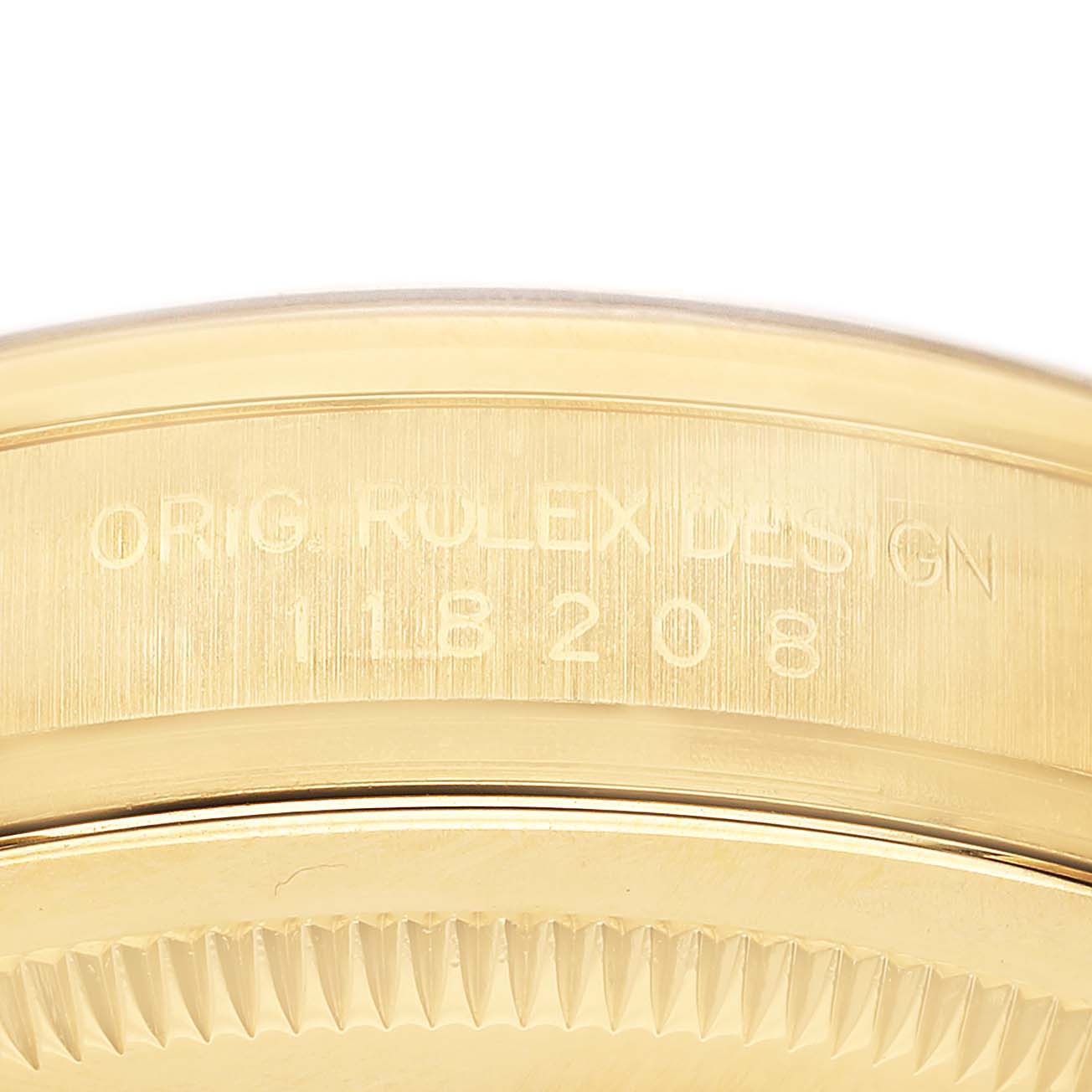 The image shows a close-up of the side of a Rolex President 118208 Men's Yellow Gold Black Dial watch case with an engraving of the design number.
