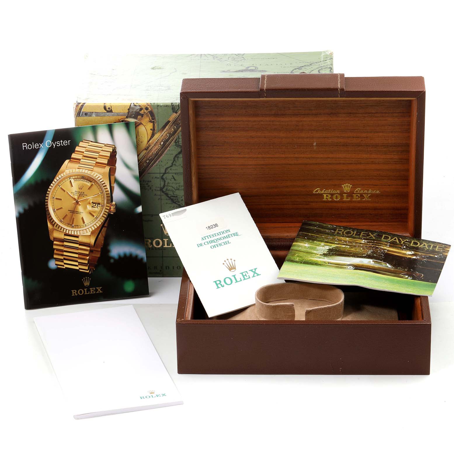 The image shows accessories for the Rolex President 18238 Men
s Yellow Gold Champagne Dial 18238 Men
s Yellow Gold Champagne Dial model, including the box, booklets, and case.