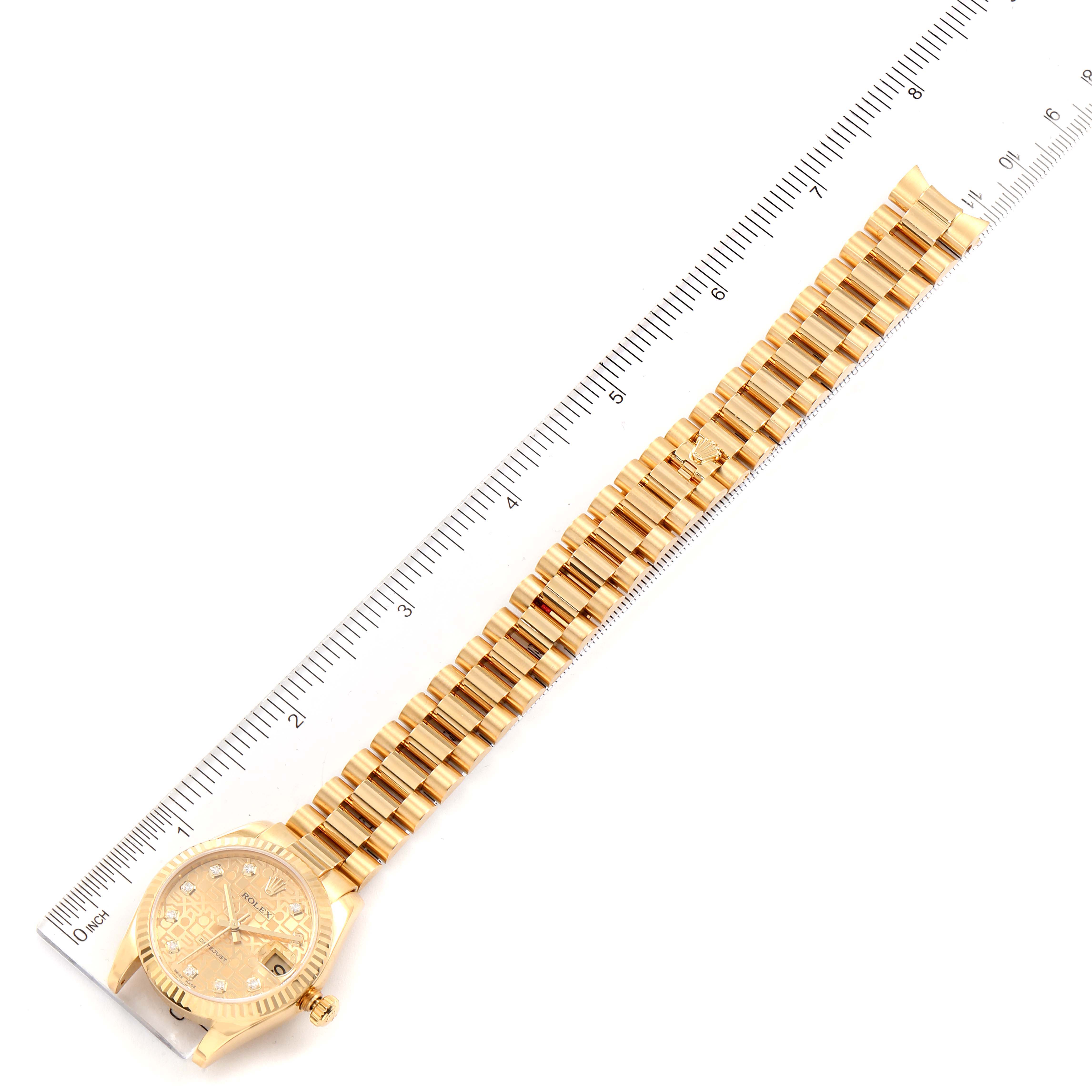 The image shows a top-down view of a Rolex President 178278 Women
s Yellow Gold Champagne Dial 178278 Women
s Yellow Gold Champagne Dial model watch alongside a ruler for measurement.