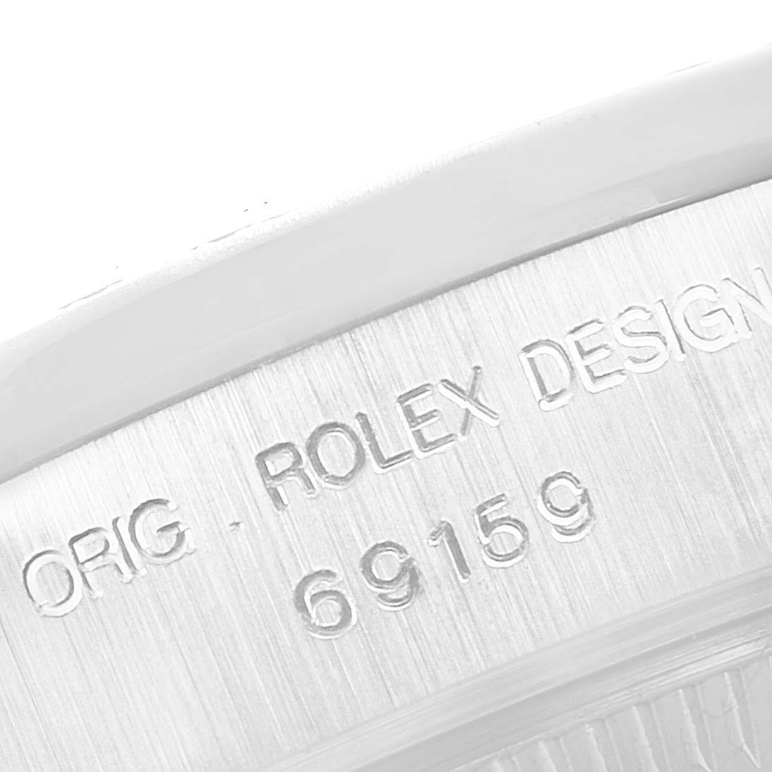 The image shows a close-up of the side of the case of a Rolex President 69159 Women's White Gold Silver Dial 69159 Women's White Gold Silver Dial watch, displaying the engraved model and design number.