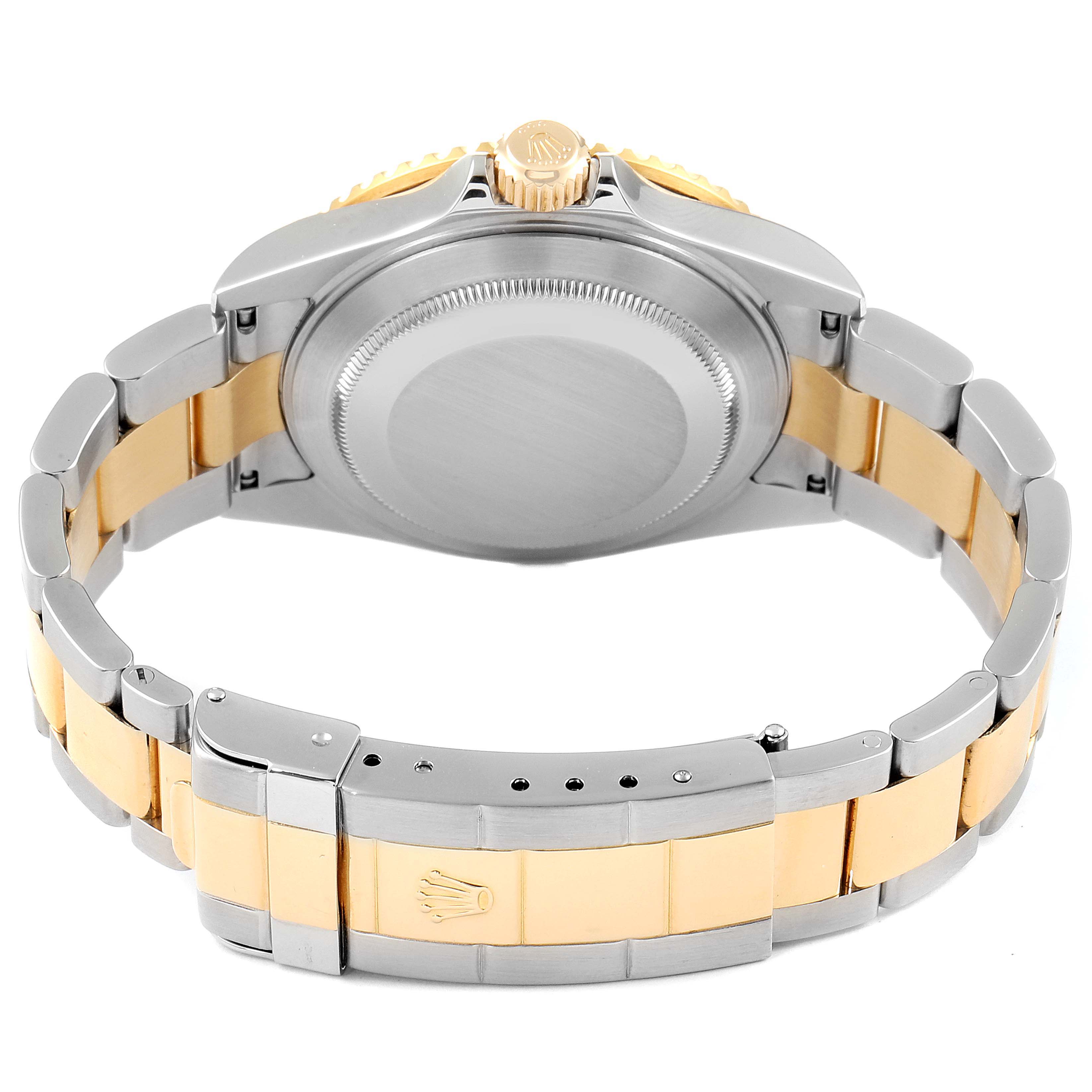 The image shows the back of a Rolex Submariner 16613 Men
s Steel and Gold (two tone) Blue Dial 16613 Men
s Steel and Gold (two tone) Blue Dial watch case and the two-tone bracelet.