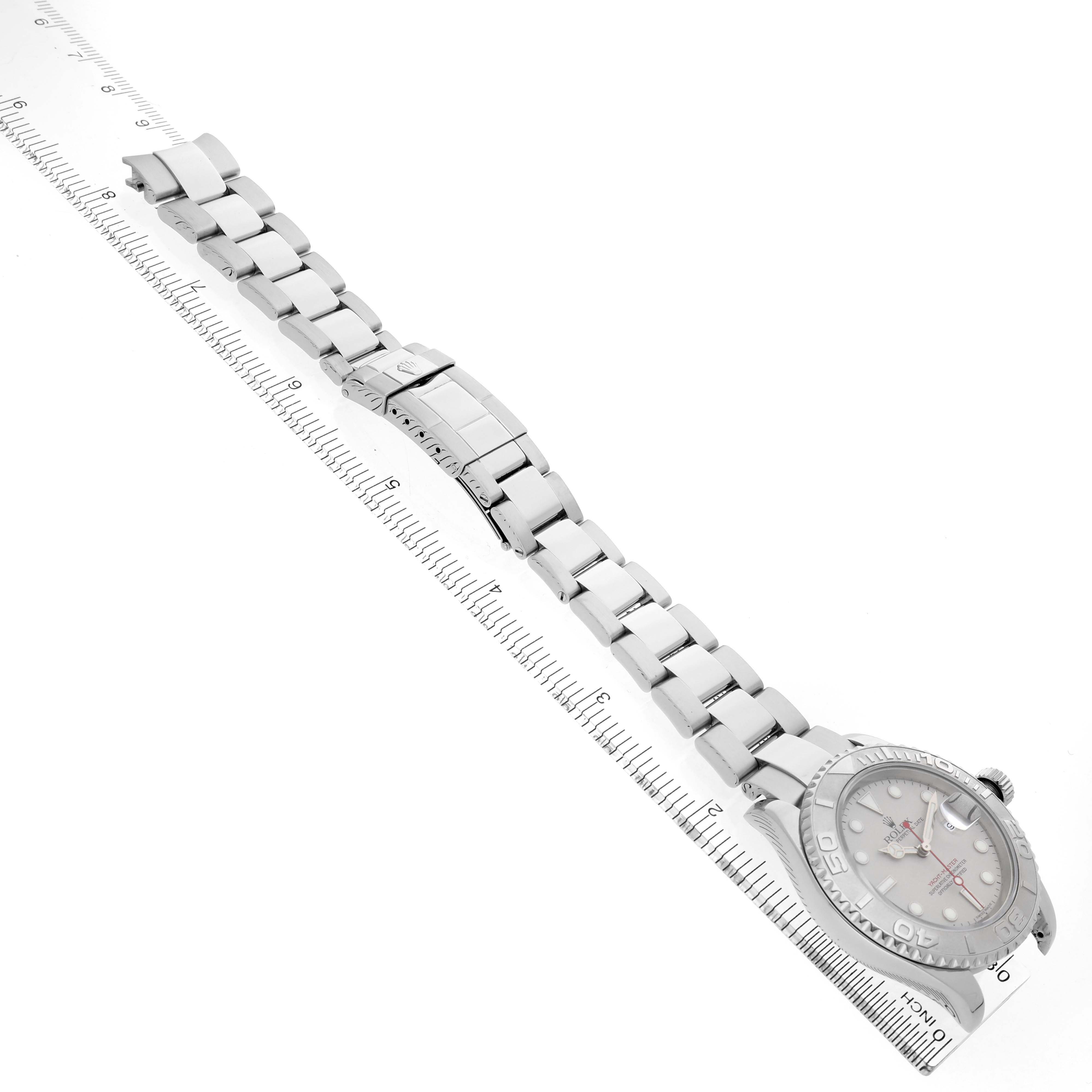 The Rolex Yacht-Master 16622 Men's Stainless Steel Silver Dial watch is shown diagonally, displaying the bracelet and face alongside a measuring ruler.
