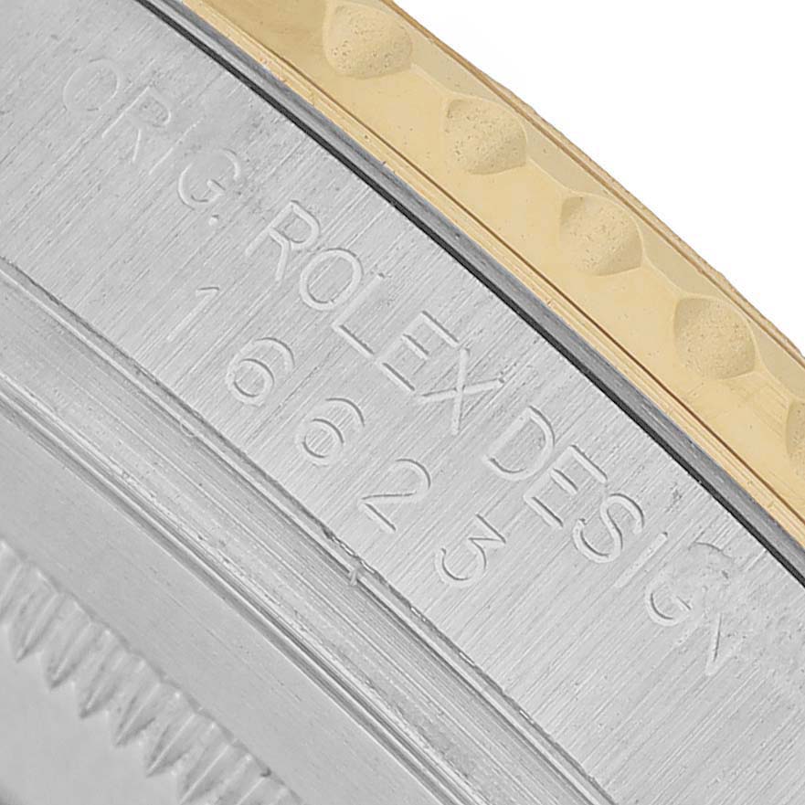 The image shows an angled close-up of the side of a Rolex Yacht-Master 16623 Men's Steel and Gold (two tone) Blue Dial, focusing on the engraved details.