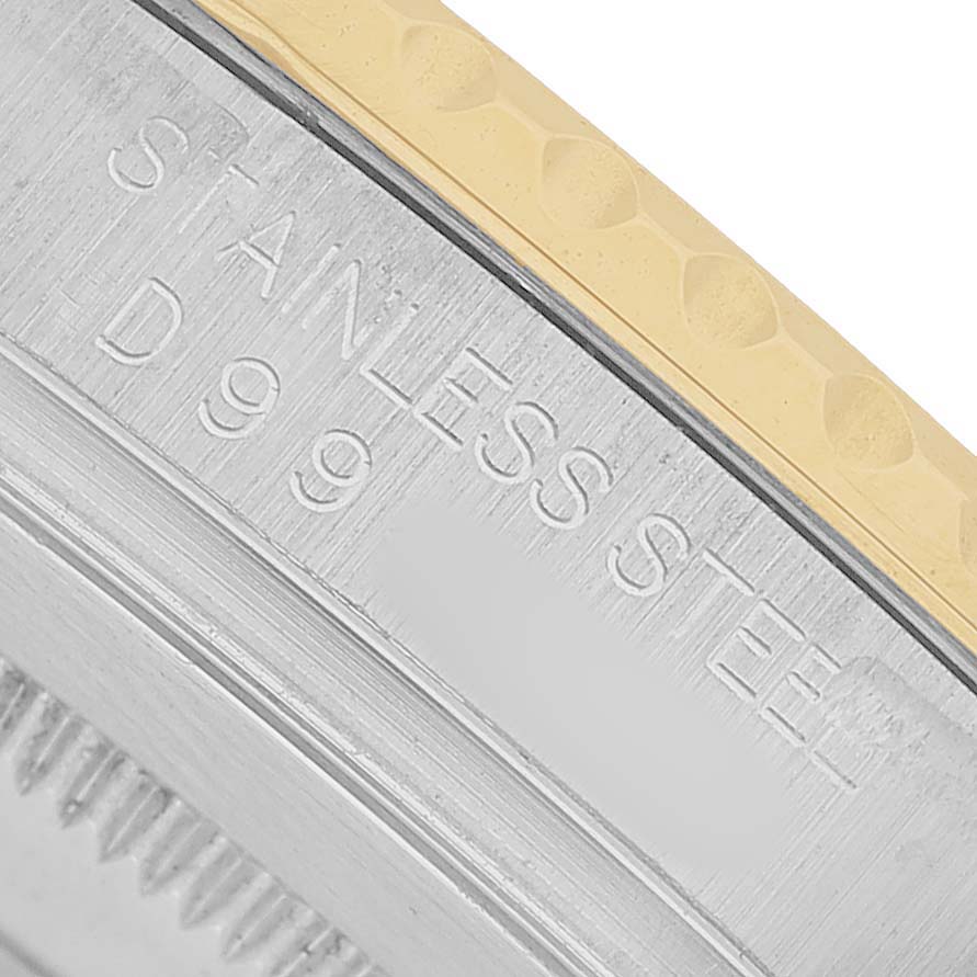 The image shows a close-up of the stainless steel side with engravings on a Rolex Yacht-Master 16623 Men's Steel and Gold (two tone) Blue Dial watch.