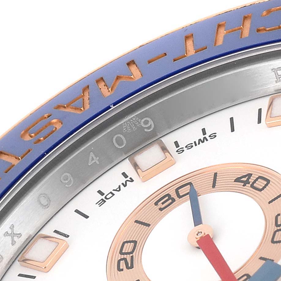 The image shows a close-up of the dial and bezel of a Rolex Yacht-Master 116681 Men's Steel and Gold (two tone) White Dial 116681 Men's Steel and Gold (two tone) White Dial watch, highlighting the numerals, indices, and part of the bezel.
