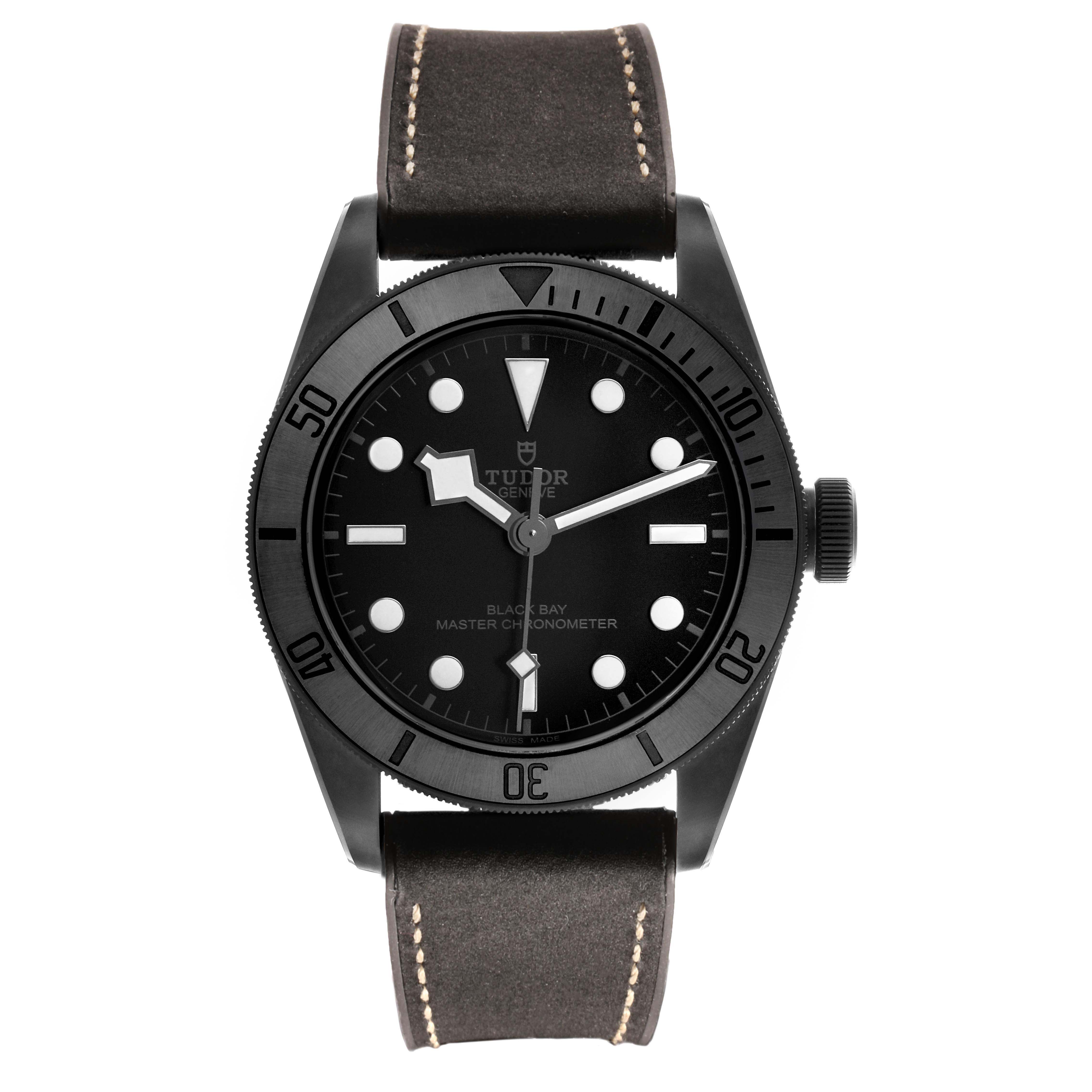 The Tudor Heritage Black Bay 79210 Men's Ceramic Black Dial watch is shown from a front angle, displaying the face, bezel, and strap.