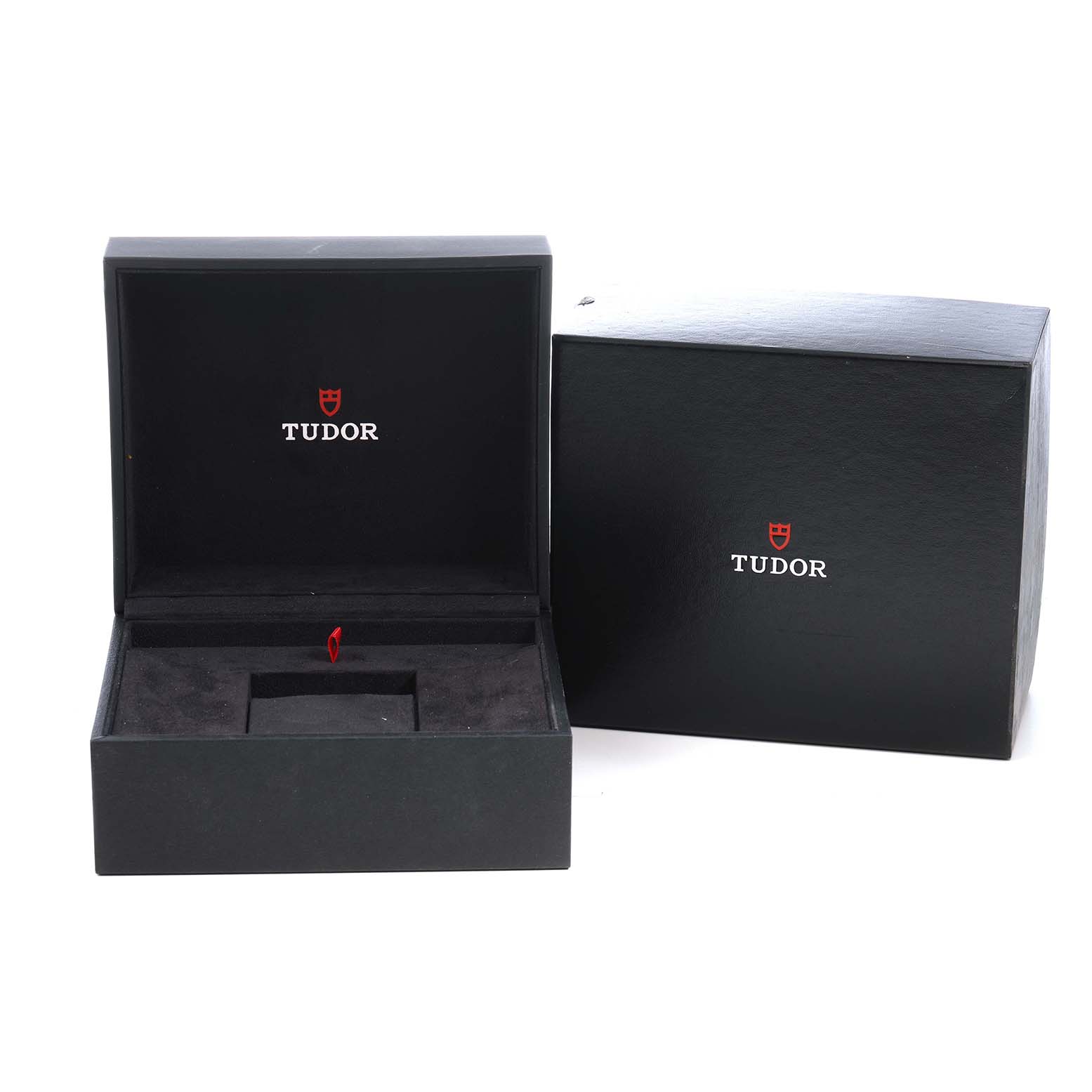 The image shows an open Tudor watch box for the Heritage Black Bay model, alongside its protective outer box.