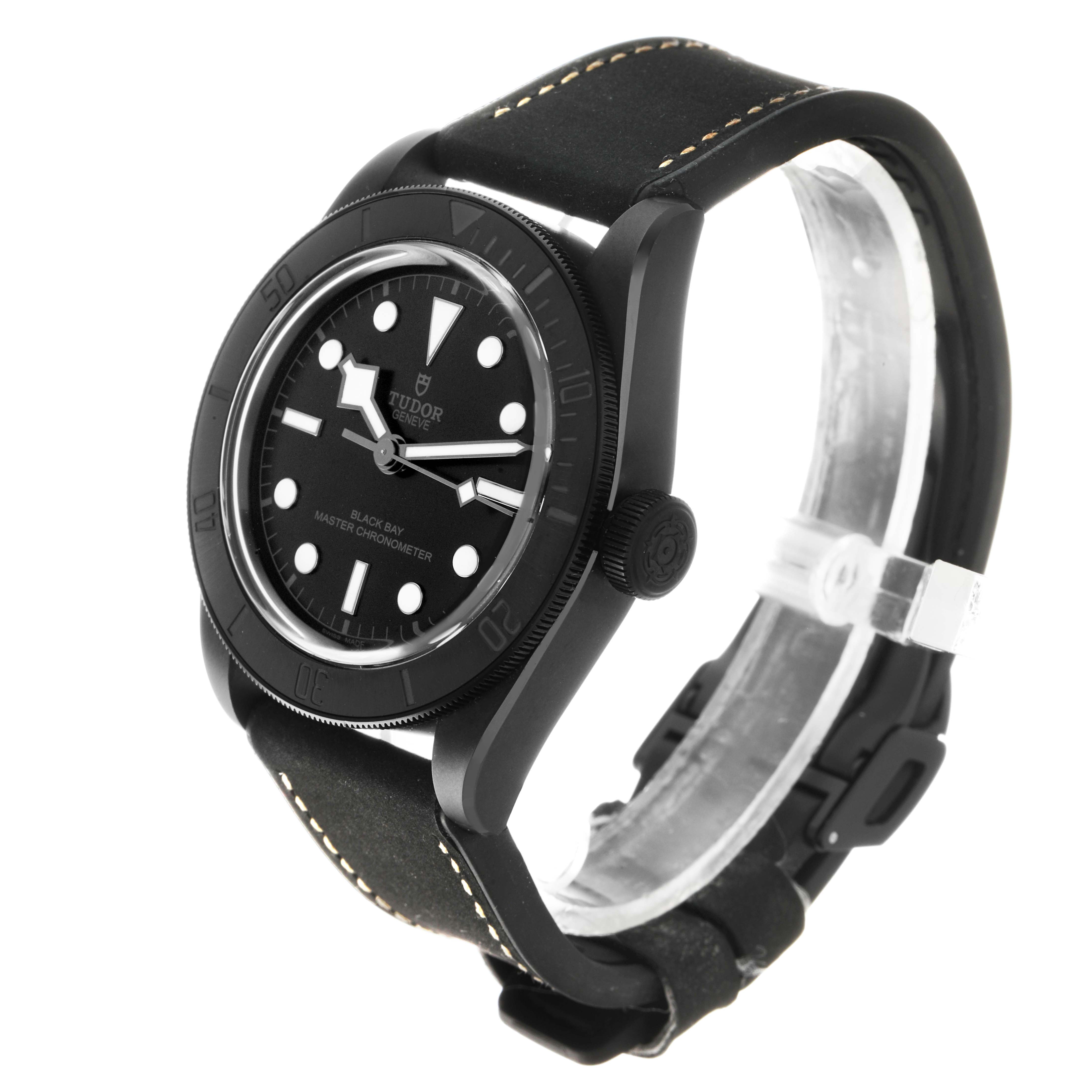 The Tudor Heritage Black Bay 79210 Men's Ceramic Black Dial watch is shown at a three-quarter angle, displaying the face, bezel, crown, and strap.