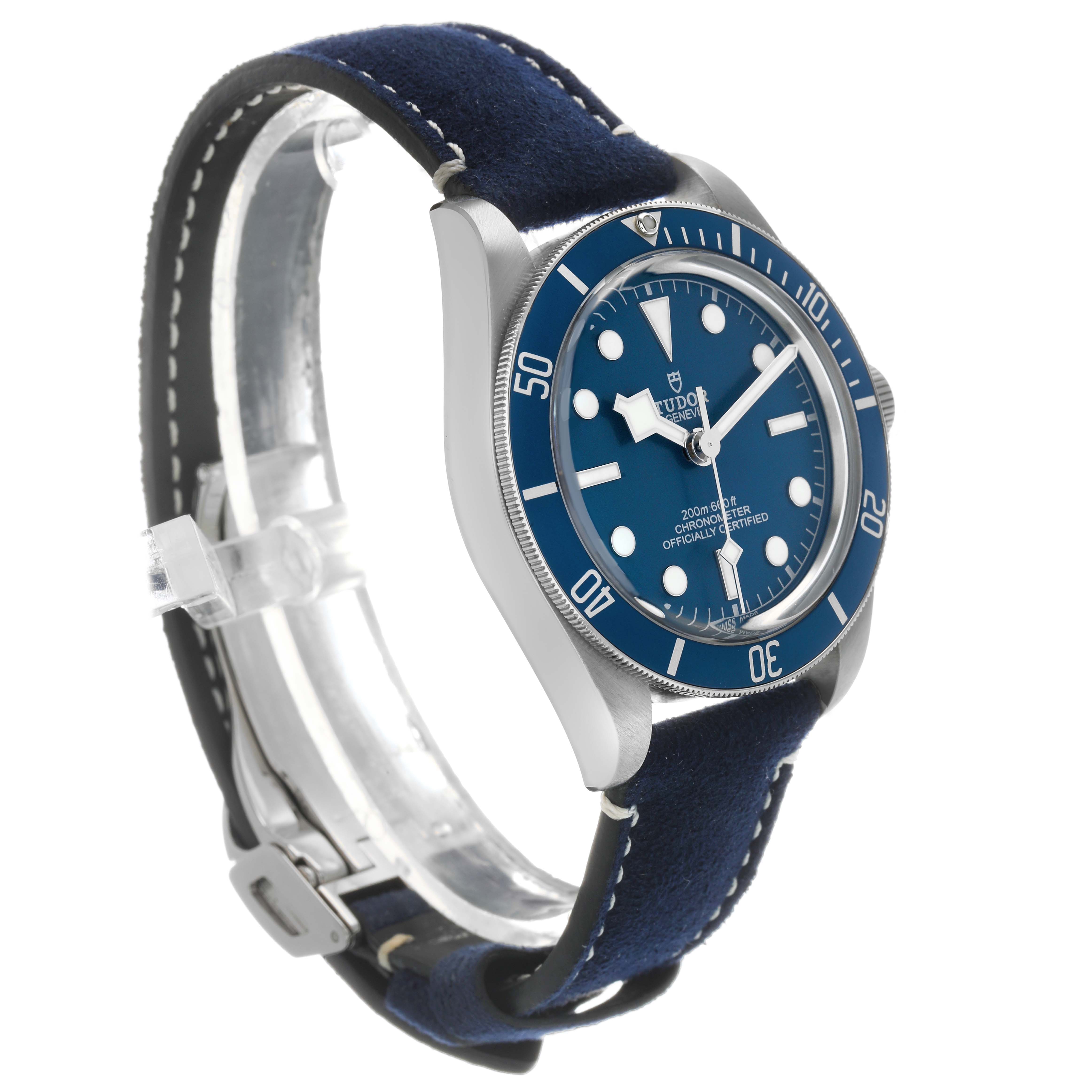 The Tudor Heritage Black Bay 79030 Men's Stainless Steel Blue Dial watch is shown at a three-quarter angle highlighting the blue dial, bezel, and leather strap.