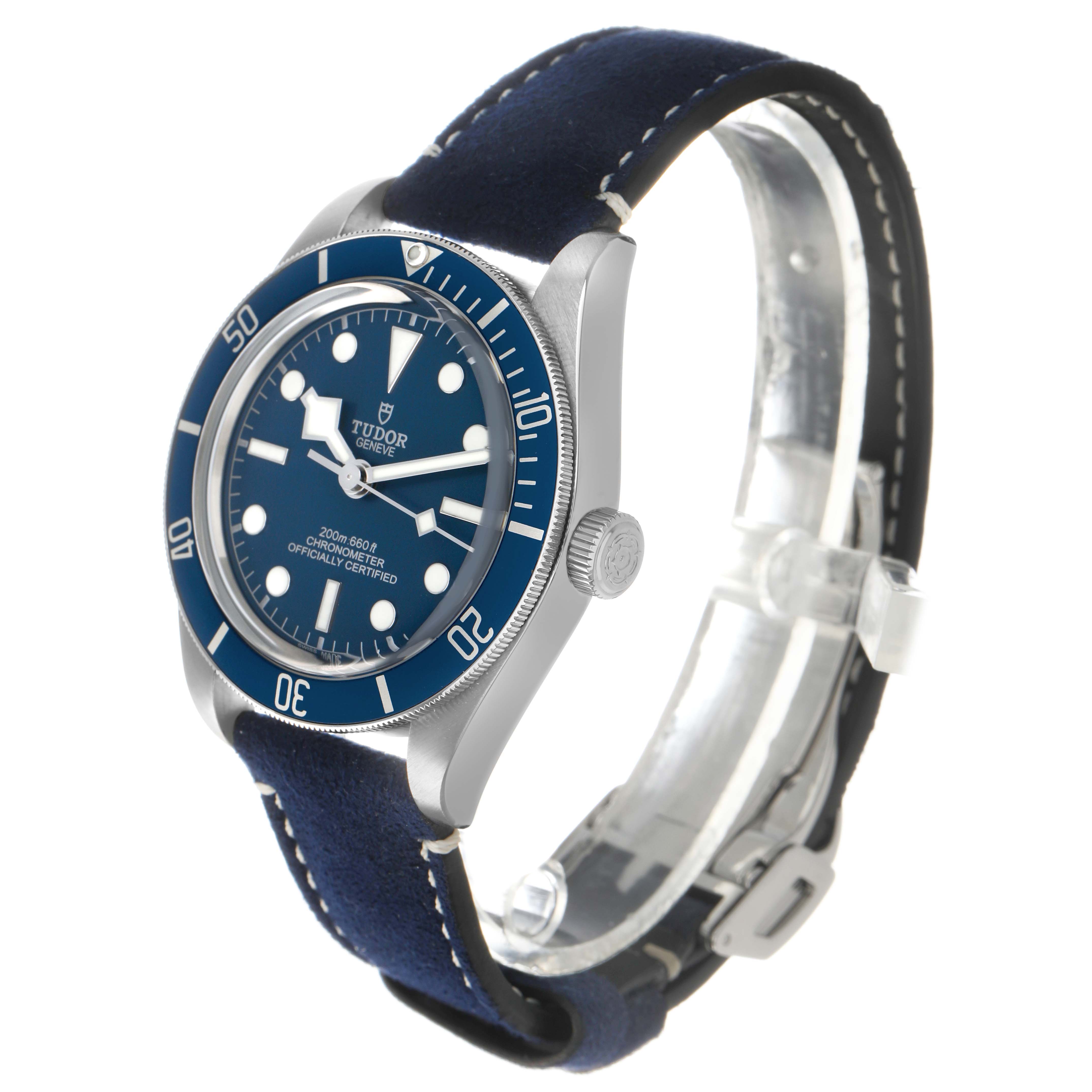 The Tudor Heritage Black Bay 79030 Men's Stainless Steel Blue Dial watch is shown at a three-quarter angle displaying its bezel, dial, crown, and strap.