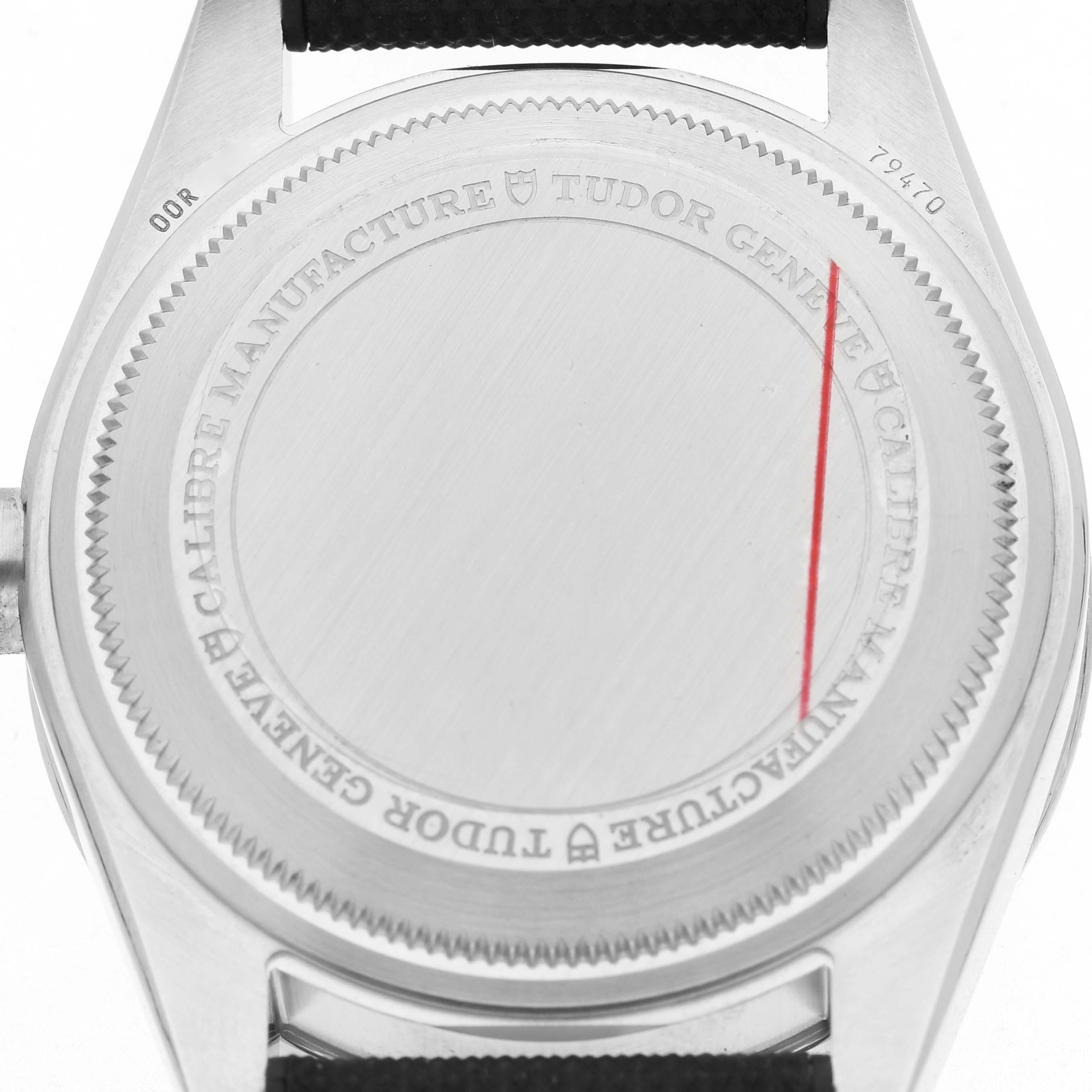The image shows the back case of the Tudor Heritage Black Bay 79470 Men's Stainless Steel Black Dial watch, featuring engraved branding details.