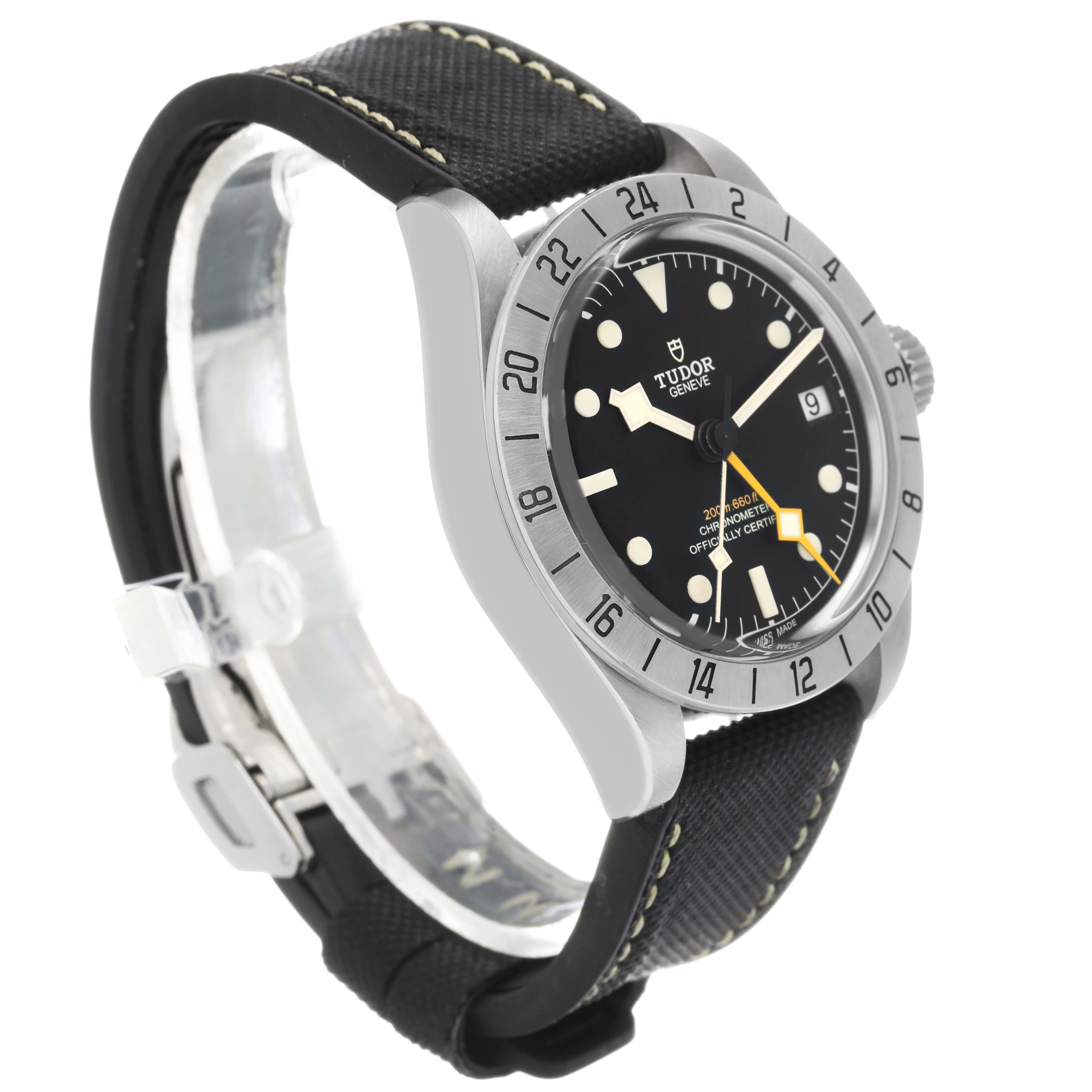 The Tudor Heritage Black Bay 79470 Men's Stainless Steel Black Dial watch is shown at a front-side angle, highlighting its face, bezel, and strap.