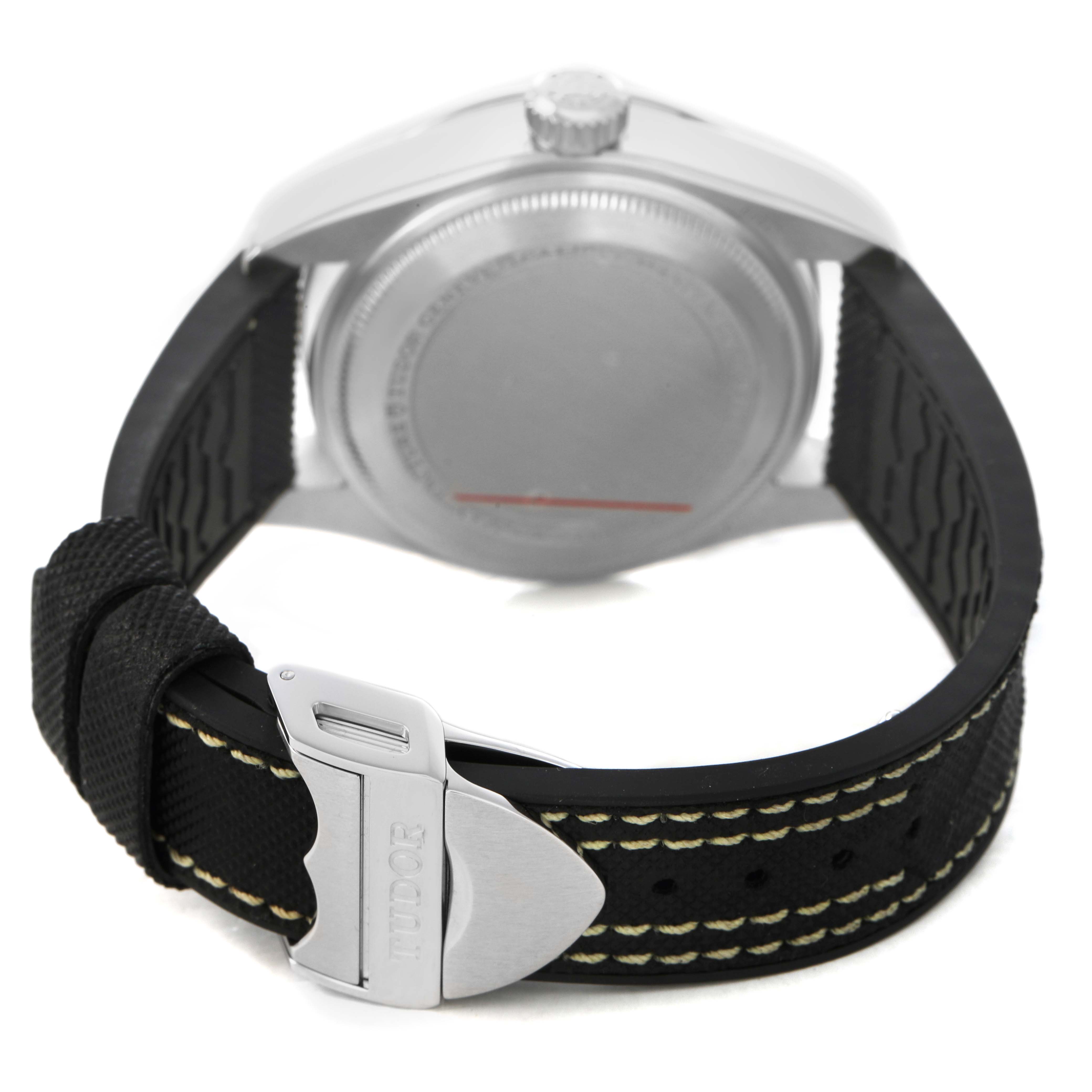 The image shows the back and side of the Tudor Heritage Black Bay 79470 Men's Stainless Steel Black Dial watch, focusing on the case, crown, and clasp on the strap.