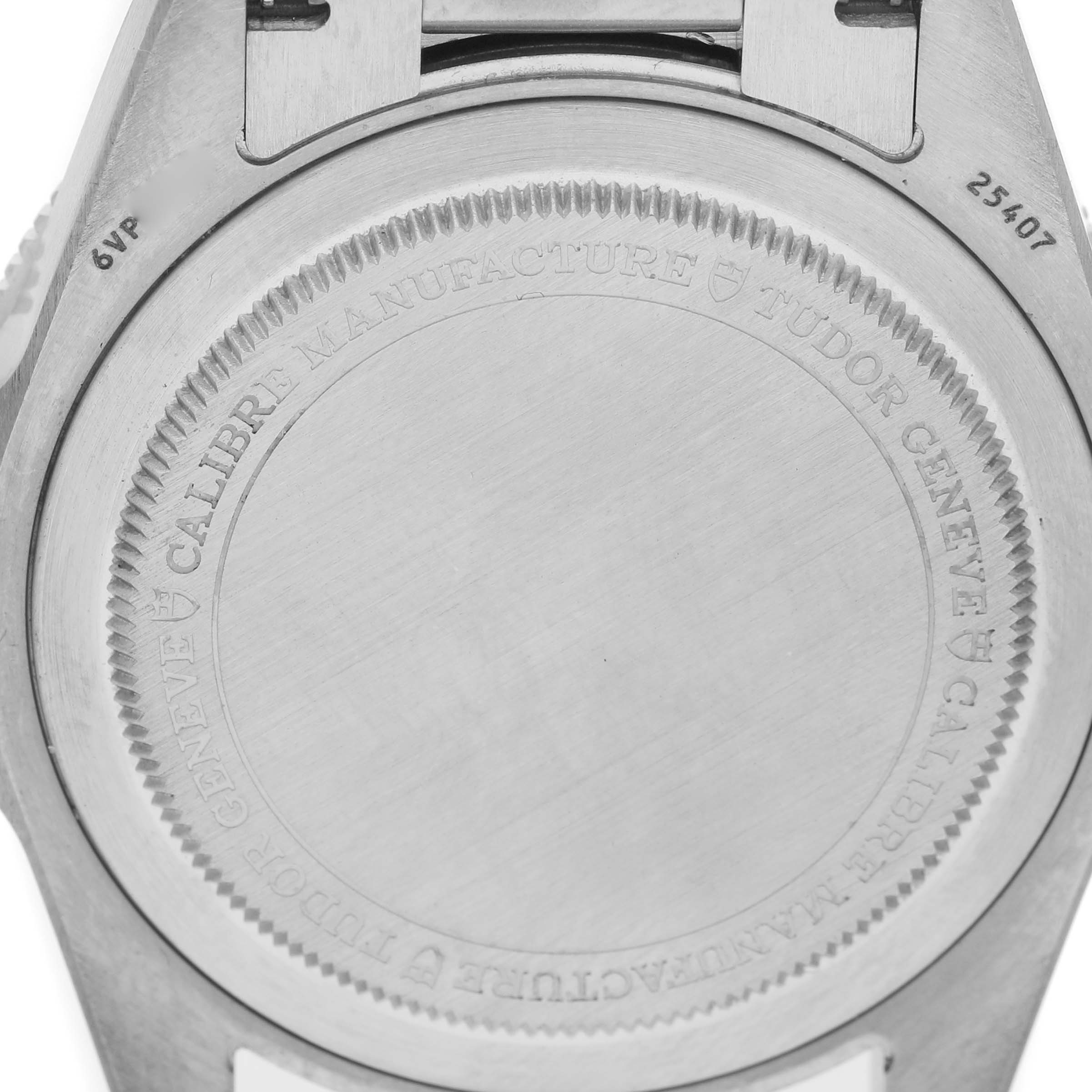 The image shows the back case of a Tudor Pelagos 25407 Men's Titanium Black Dial watch, focusing on the engraved details.